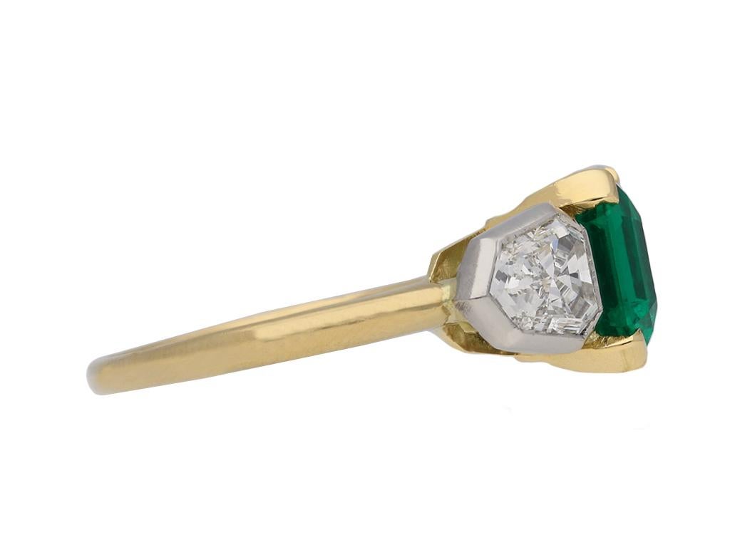 Art Deco Colombian emerald and diamond ring. Set to the centre with one octagonal emerald-cut natural Colombian emerald with no colour enhancement and minor clarity enhancement in an open back claw setting with an approximate weight of 2.00 carats,