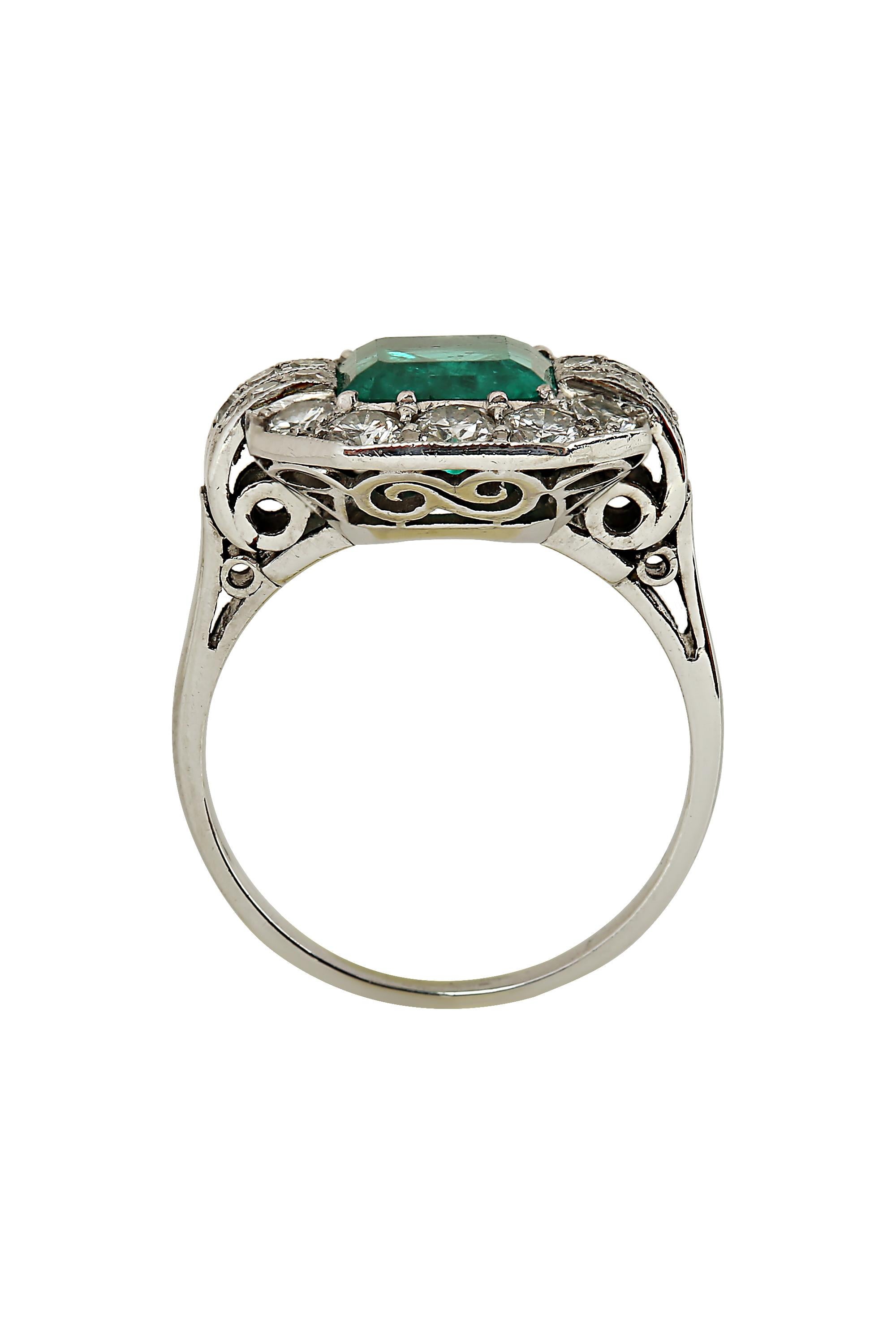 A sublime Art Deco ring highlighting a richly saturated octagonal 2 carat Colombian emerald in a chic geometric diamond mounting fabricated in 18 karat white gold. With GIA report # 1166842555 stating that the emerald is Colombian in origin with F1