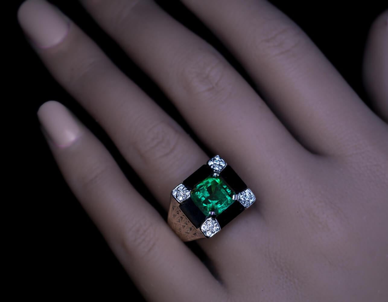 French, circa 1930  This one-of-a-kind Art Deco ring is crafted in 18K pale yellow gold and platinum. It features an excellent 2.72 ct square shape Colombian emerald of vivid bluish green color. The emerald is set in a rectangular pyramid-shaped