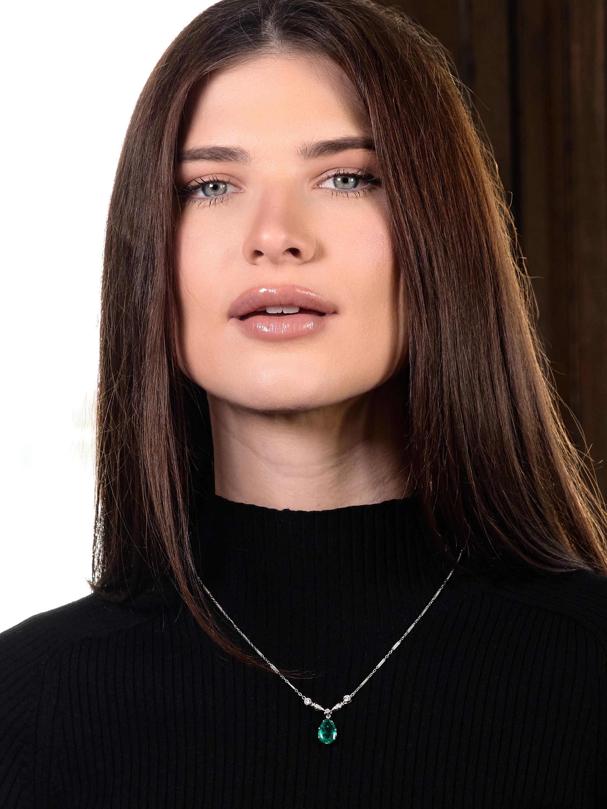 Comprised of a fancy elongated bar link chain with a pear cut Colombian emerald drop station
Weighing approximately 2.83 carats - transparent medium green in color with minor traditional clarity
Prong set and suspending from old European cut diamond