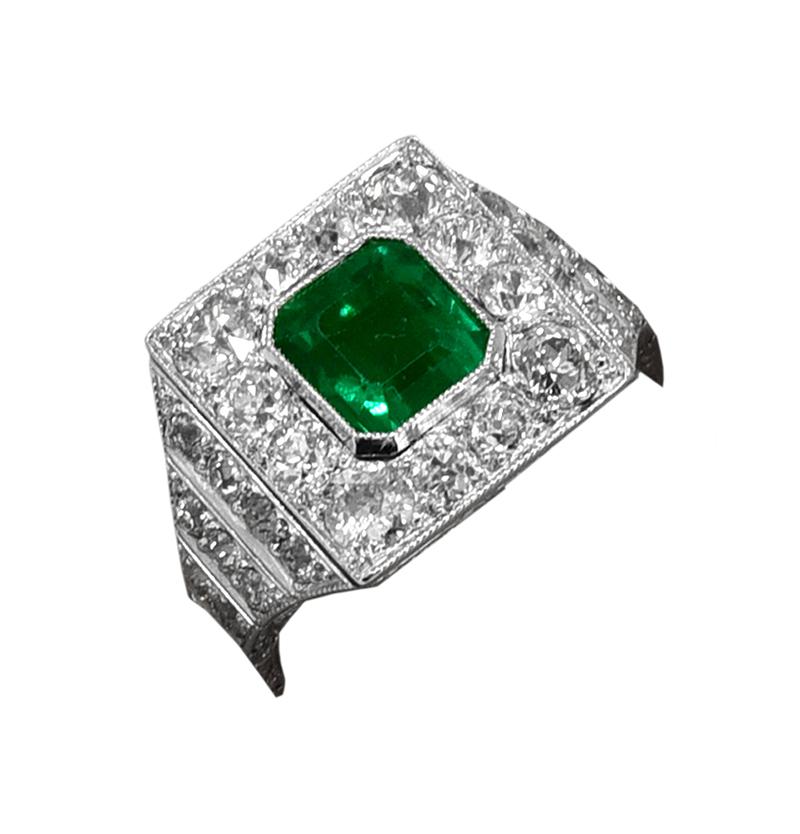 Superb example of Art Deco jewelry.  Stunning Emerald-Cut Colombian Emerald, approximately 1.60 carats.  Saturated Emerald green color.  Accompanied with an  AGL certificate for the Emerald.  In a step-cut platinum mounting, encrusted with over 2