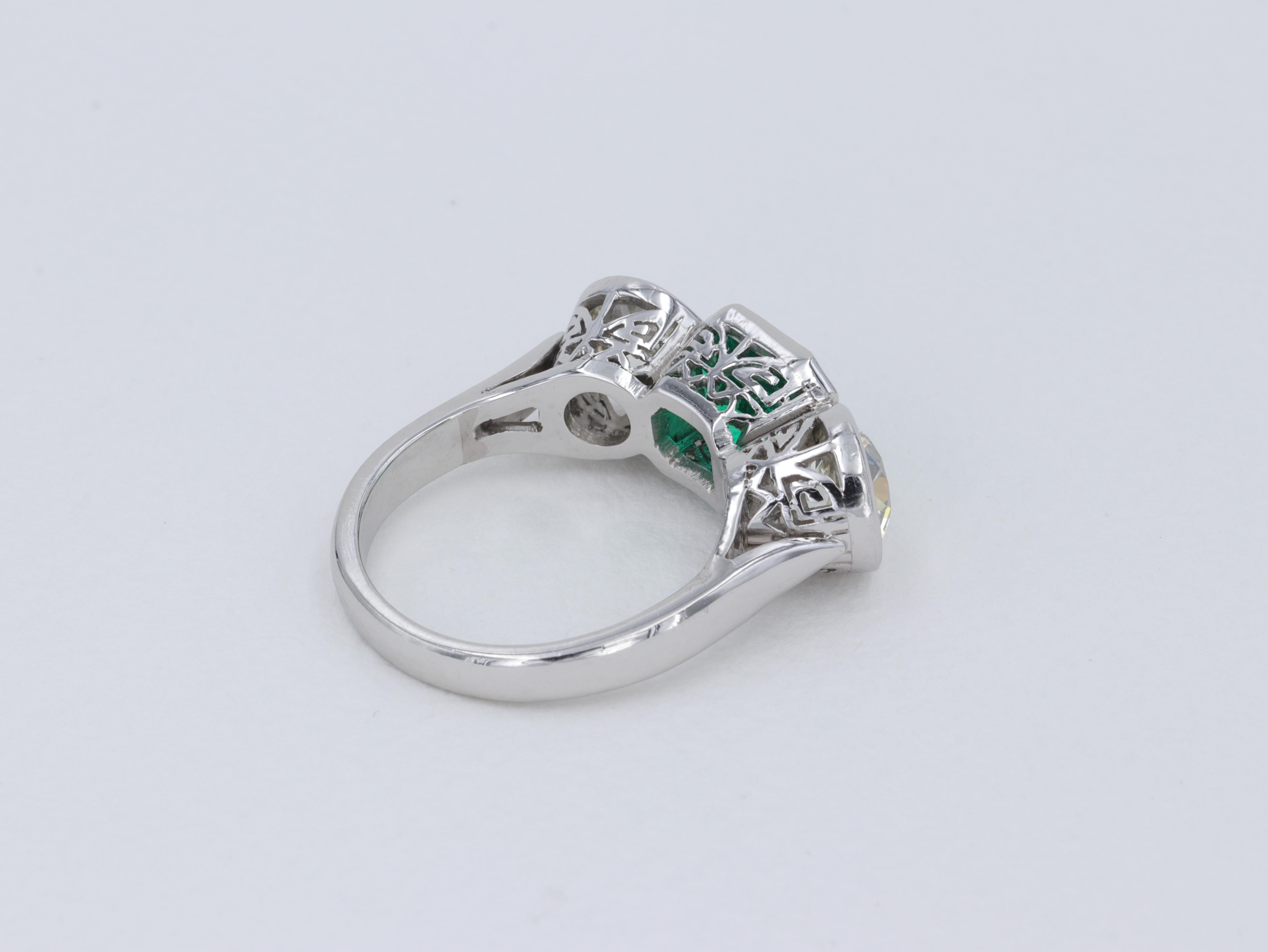 Women's or Men's Art Deco Colombian Emerald and Old European Cut Diamond 3 Stone Ring in Platinum For Sale