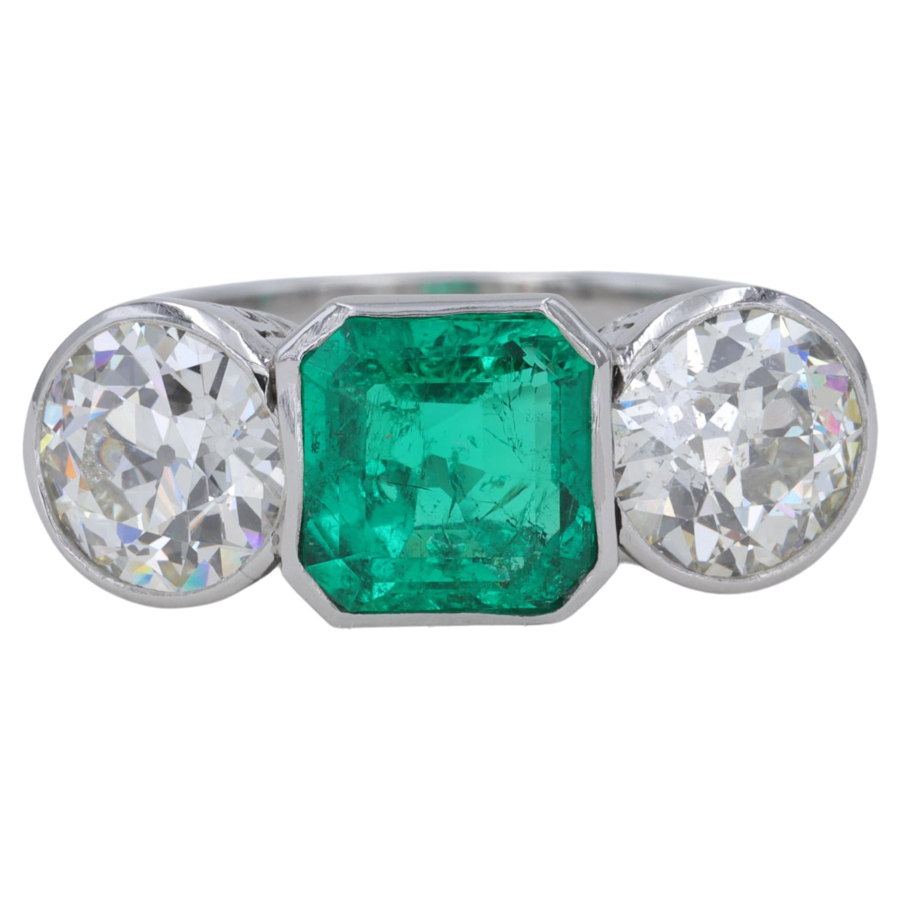 Art Deco Colombian Emerald and Old European Cut Diamond 3 Stone Ring in Platinum For Sale