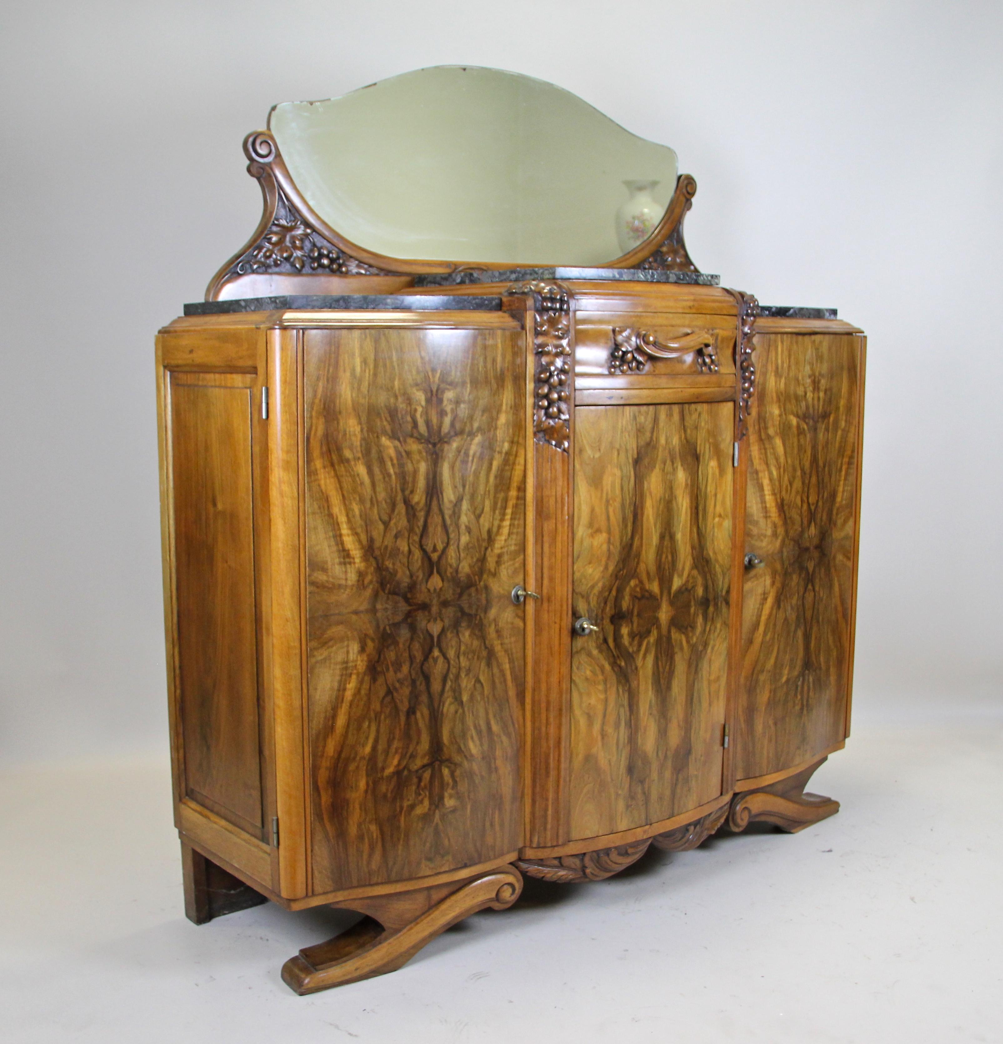 Unusual Art Deco commode from France, circa 1925. Wonderful bookmatched burl on the front was set in a very graceful manner. The unique shaped Art Deco Buffet comes with three large doors, underlined by an exceptional grain, that can be wide opened
