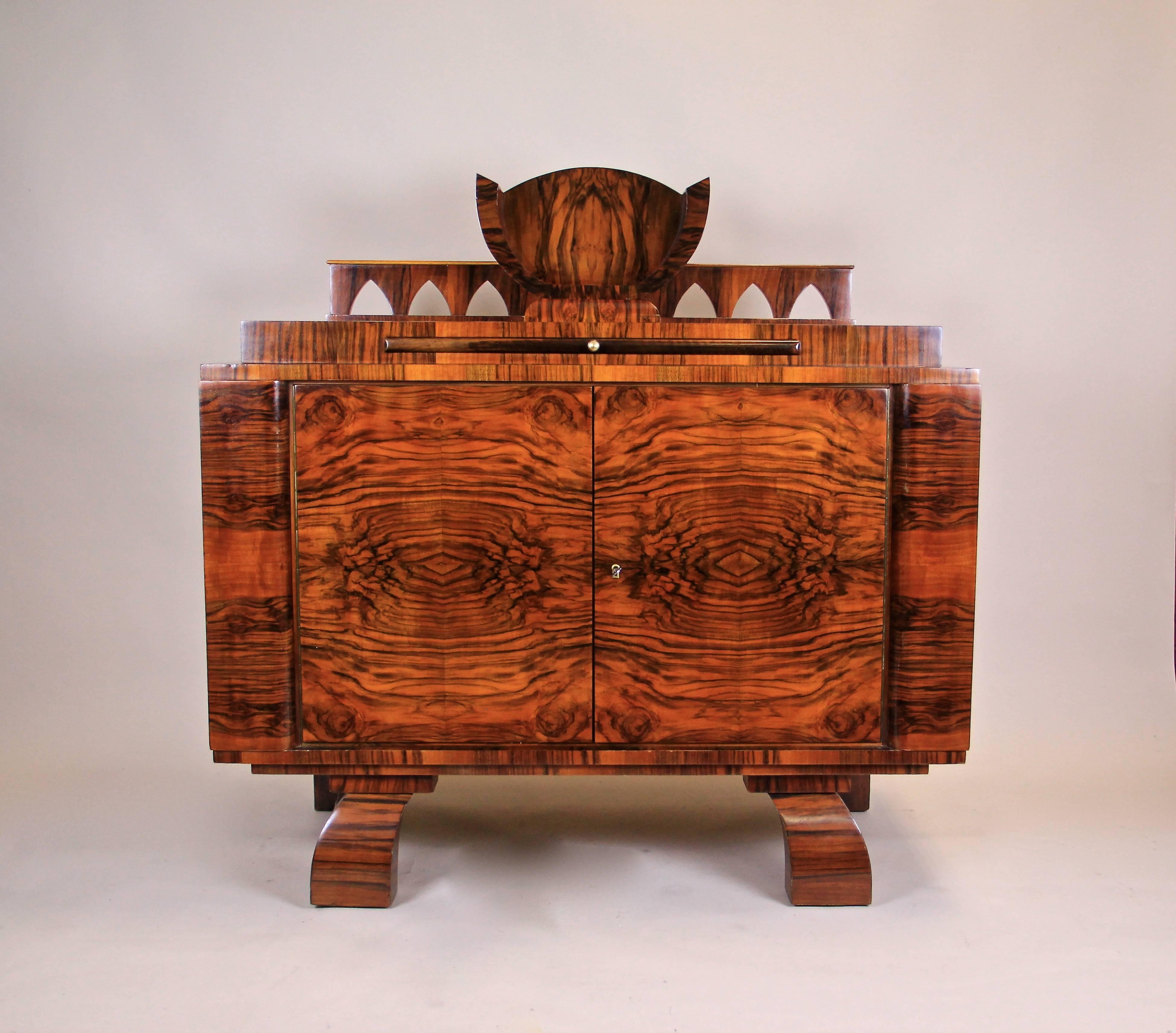 Outstanding Art Deco commode or sideboard from the period in Austria circa 1925. Veneered with finest burr walnut this commode impresses with an exceptional grain. The mirror matched veneer was set in perfection to enhance the unique shape. A