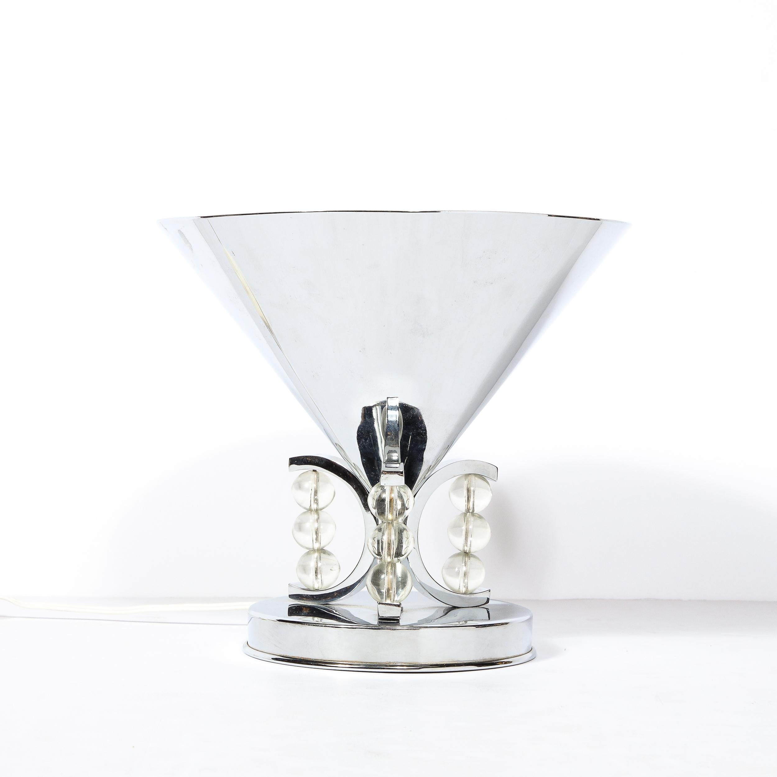 This Art Deco Conical Uplight in Chrome originates from the United States Circa 1935. An embodiment of Art Deco, the piece is an excellent example of elegant sculptural detailing and luxury along with streamline and machine influenced material