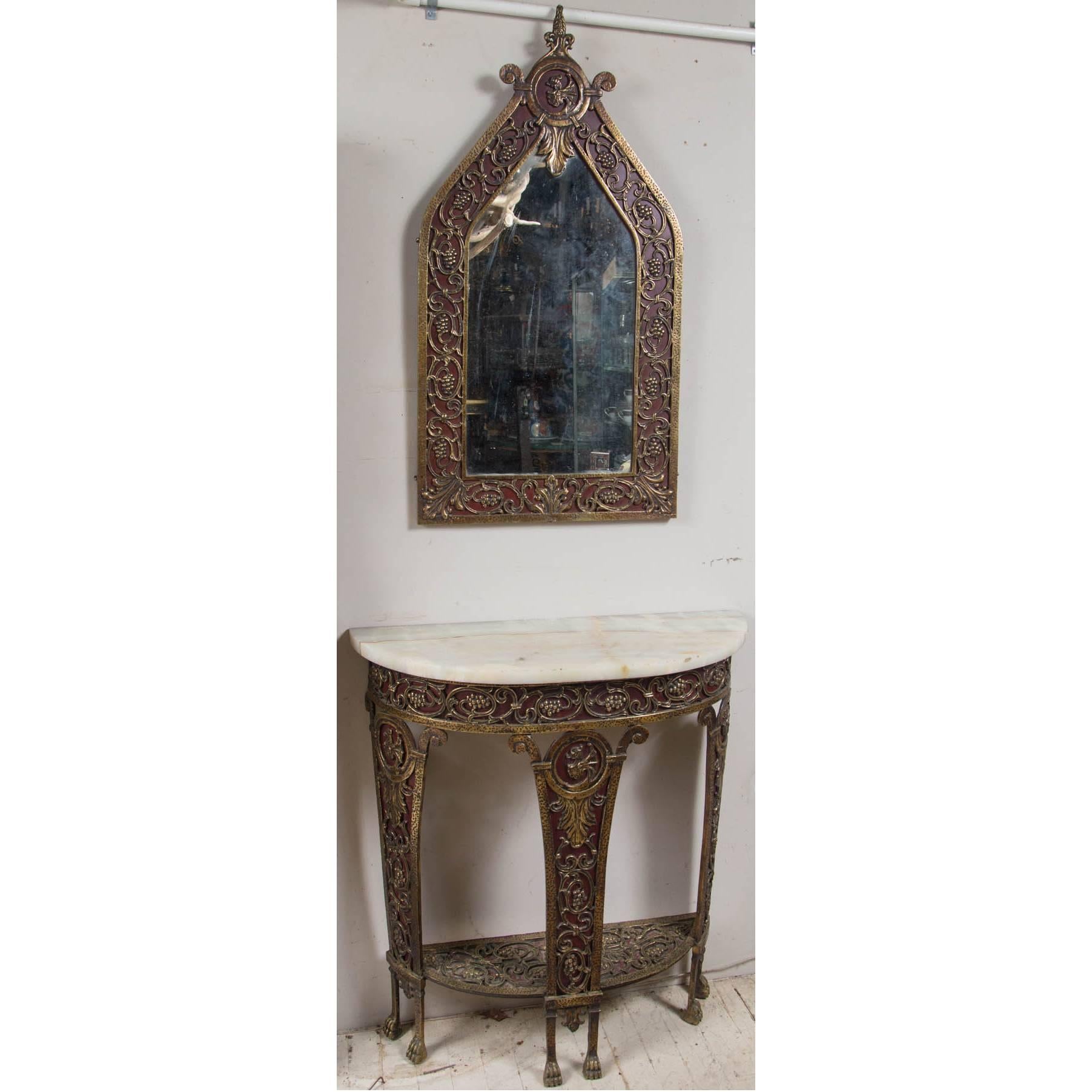 Made of brass and intricately designed with dragons, clusters, vines and leaves
Alabaster demilune top
Paw feet
The open work of the brass is backed by dark red painted metal.
The mirror measures 40.75 x 21.5
Measurements below are for the