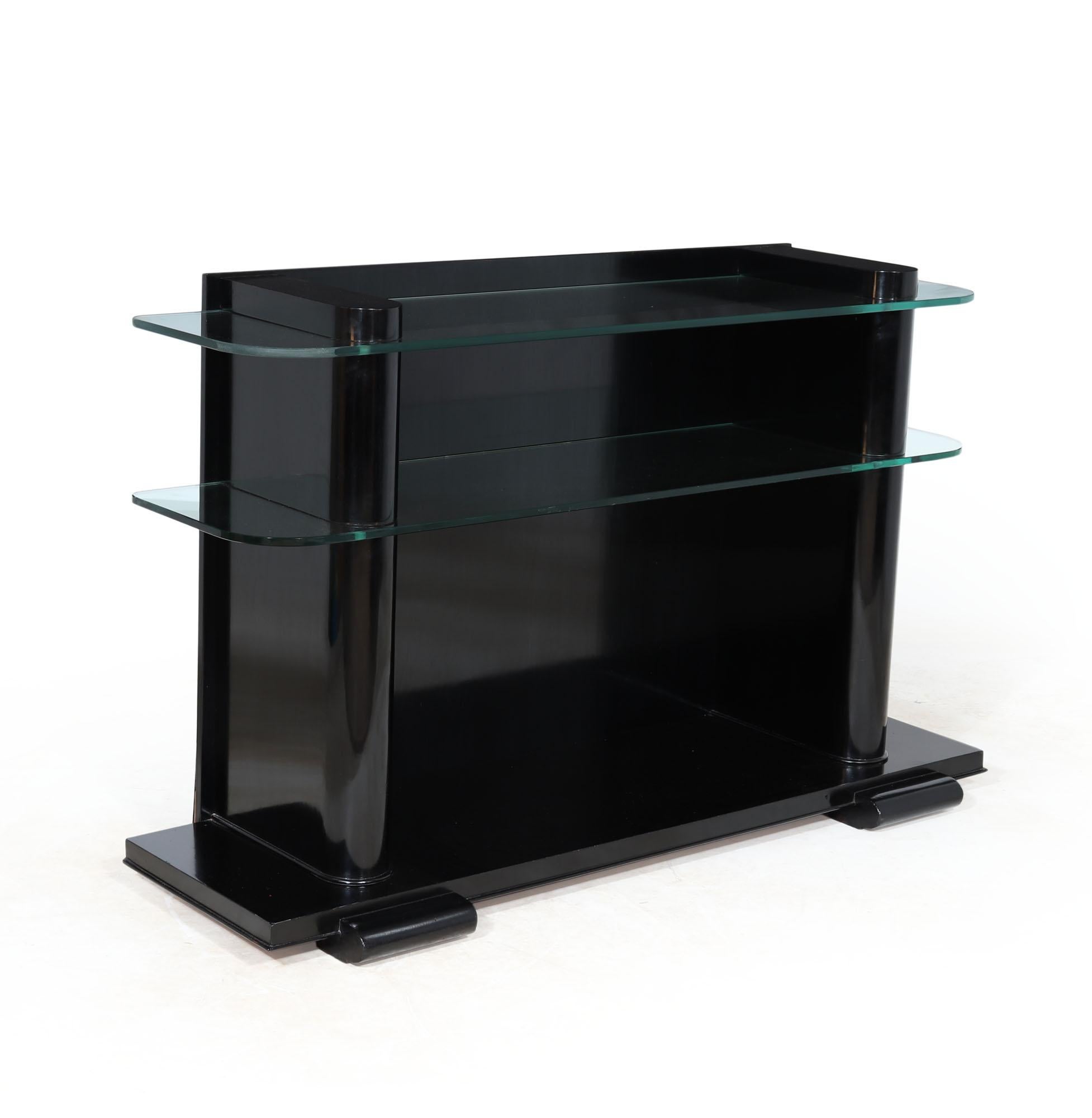 Elegant Art Deco ebonised wood and glass console table designed and produced in Belgium by De Coene Frères in the 1920’s, the console table has two upright with thick glass shelves between, the glass is original and has one small chip to the lower