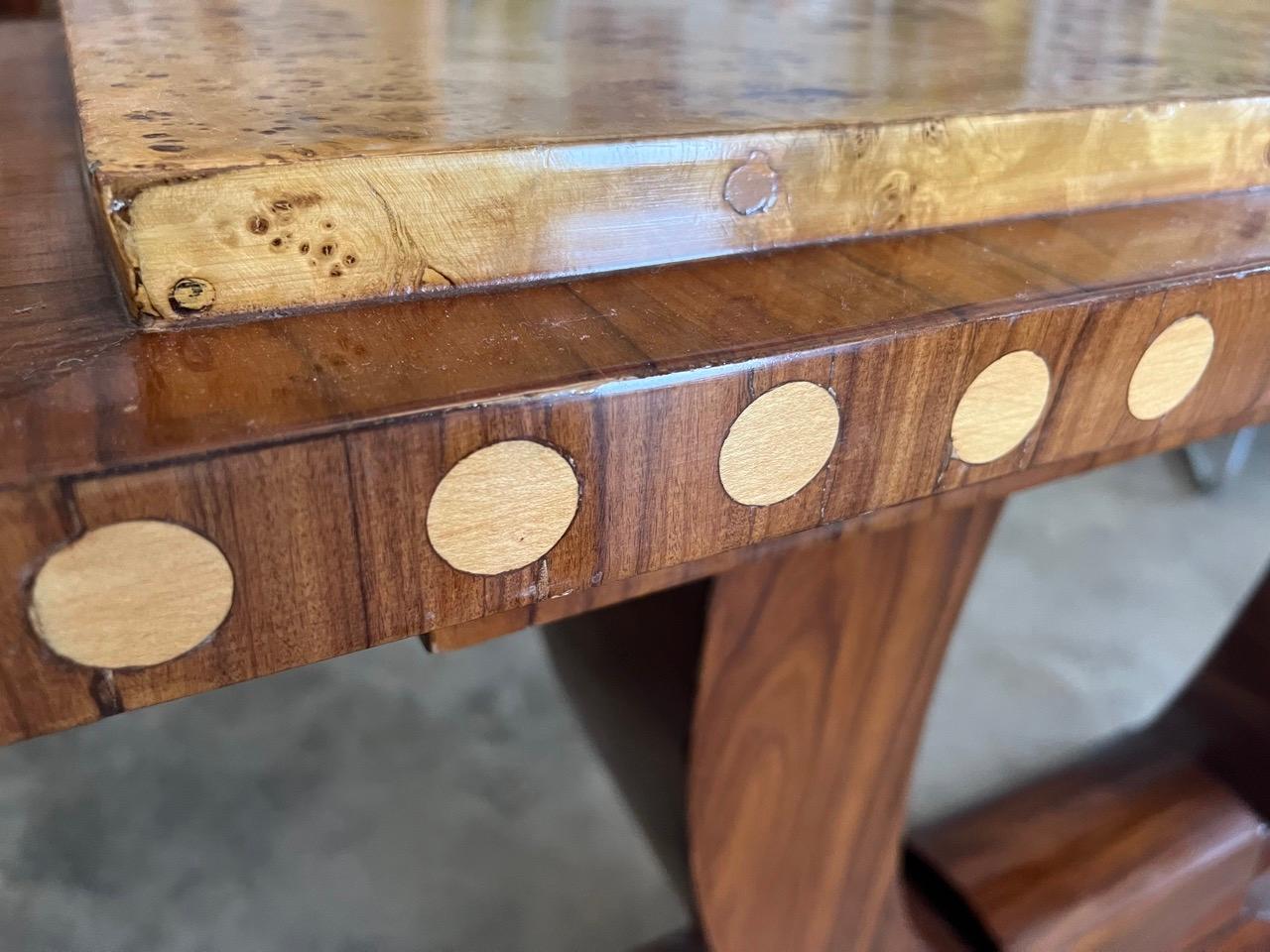 This piece is an exceptional Art Deco console with impressive burl top and circular inlay details around the perimeter.  The wood is also highly lacquered which gives the console a lovely sheen.  Dimensions of the console are 49