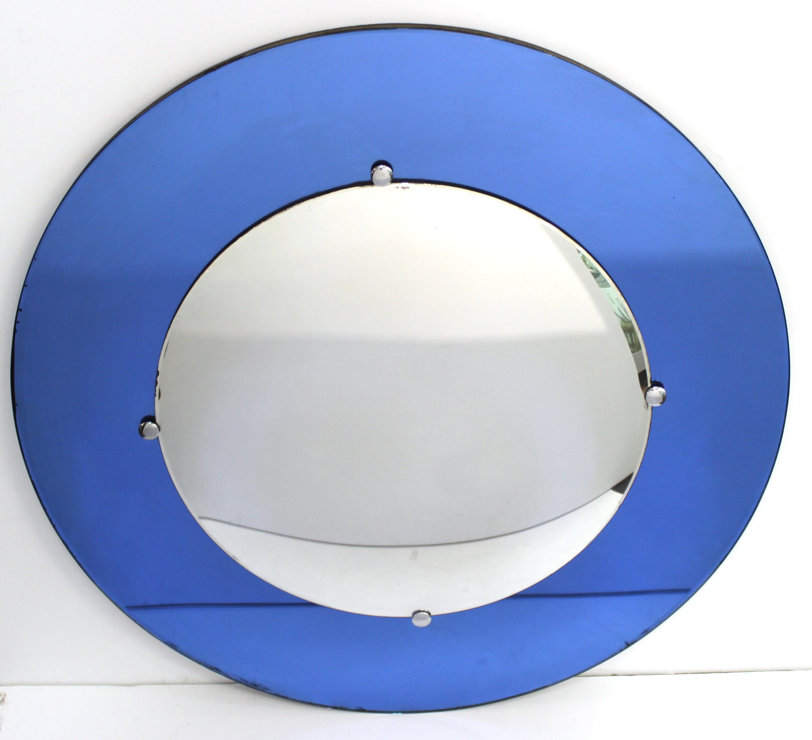 American Art Deco period circular mirror with a convex clear mirror in the center, atop blue flat mirrored background border. The mirror is mounted on a wooden back and was likely made during the 1930s. In great vintage condition with