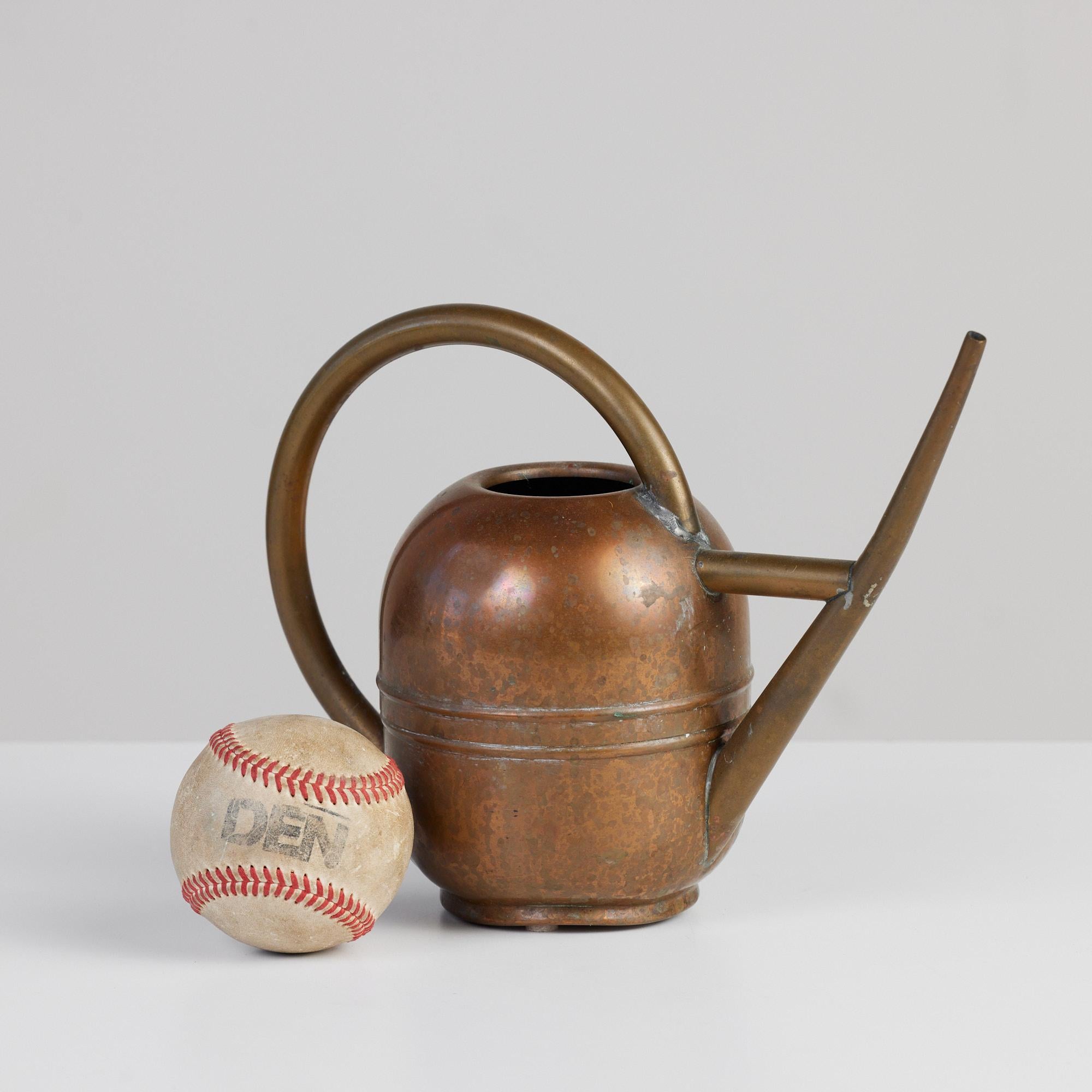 Art Deco copper and brass watering can c.1930's, Chase USA. This piece features a copper body and brass handle and spout. Vessel is impressed with [Chase USA] and feature the Chase Minotaur Archer logo on the underside.

The Chase Brass and Copper