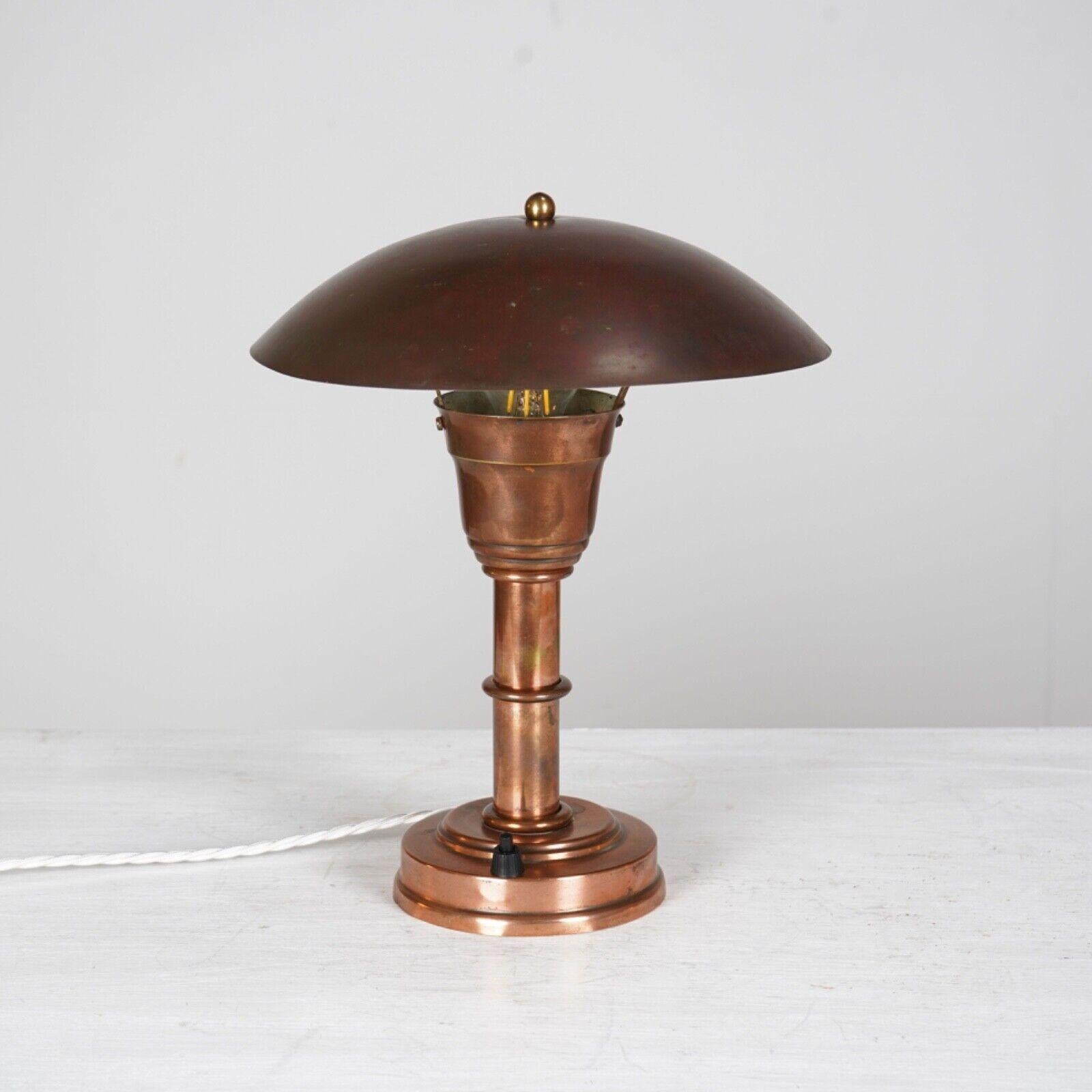 French 1930s copper desk lamp. Nicely patinated adjustable shade supported by a single column on a stepped base with push switch.
 Re-wired and PAT tested.
 
 
Dimensions
 
H 33cm , D 25cm (shade) D (at base 12cm)
 
About Us  
We are Stowaway London