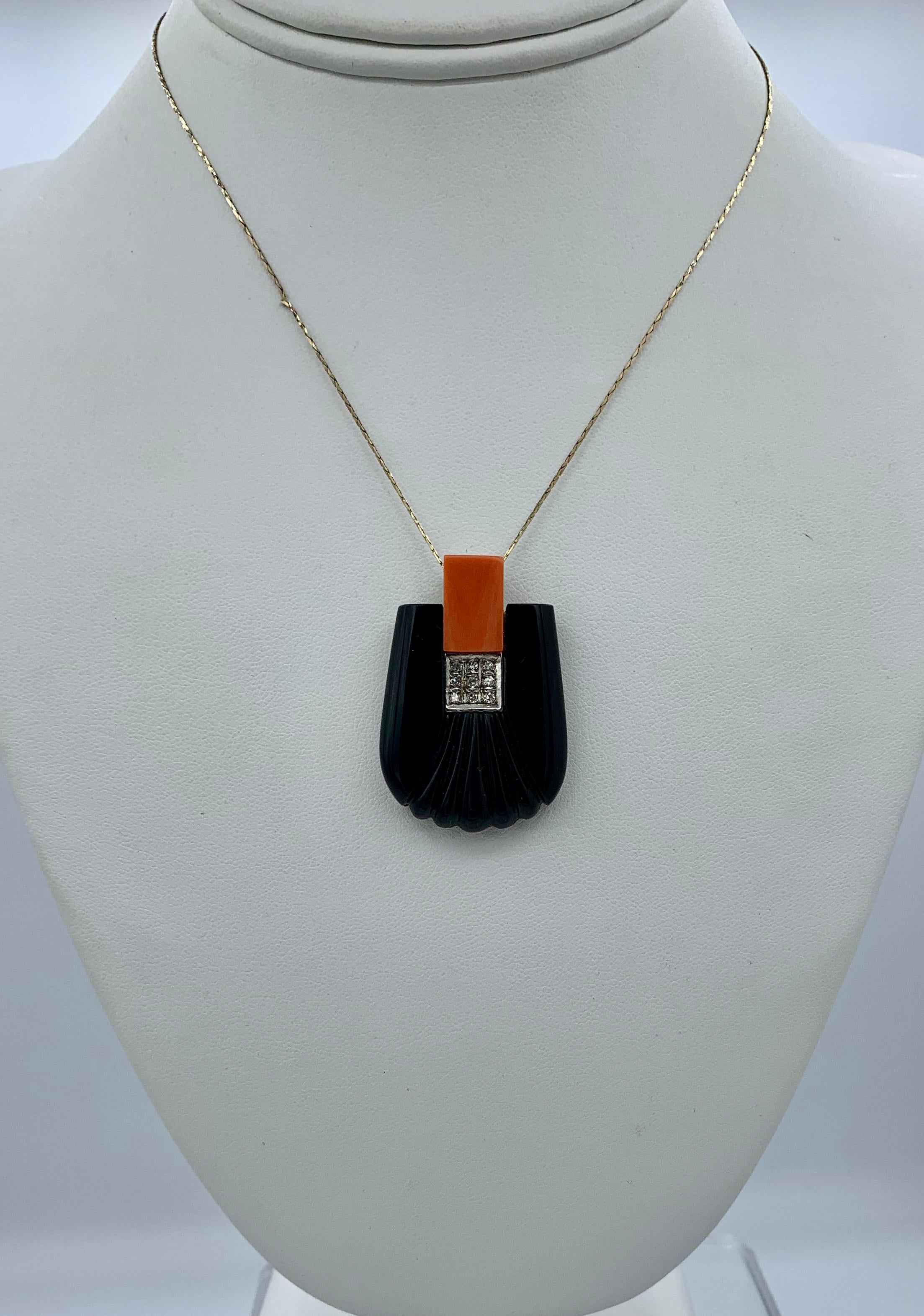 This is a stunning Antique Art Deco - Retro Pendant in Black Onyx with a stunning nine Diamond checkerboard pattern in the center with a vivid Coral gem at the top and set in 14 Karat Gold.  The Onyx, Coral and Diamond Pendant has fabulous Art Deco