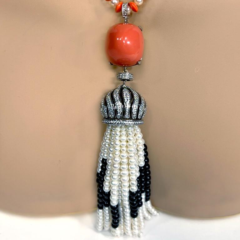 Art Deco Style Coral Pearl Diamond Costume Jewelry Tassel Necklace by Clive Kandel

From our Art Deco Paris museum archives, come this exclusive creation of a coral and pearl neclace suspending a CZ set, diamond look, large manmade coral cabochon,