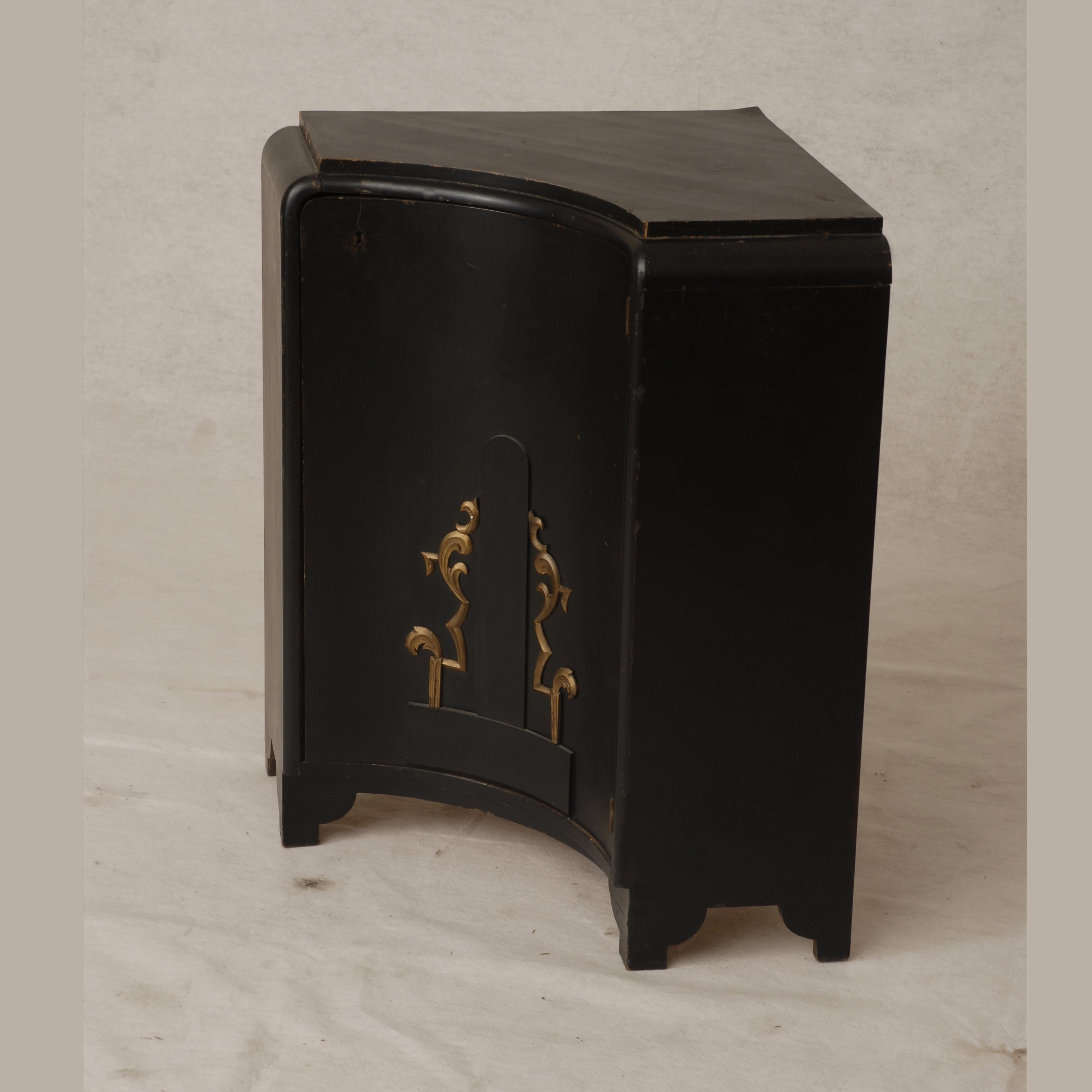 One bent concave door ebonized and gilded decor corner low cabinet.
Deigned in 1920s by Lajos Ludwig Kozna, 1884–1948 Hungarian architect, interior and furniture designer, and graphic artist.
He studied at the Budapest Imperial Joseph College