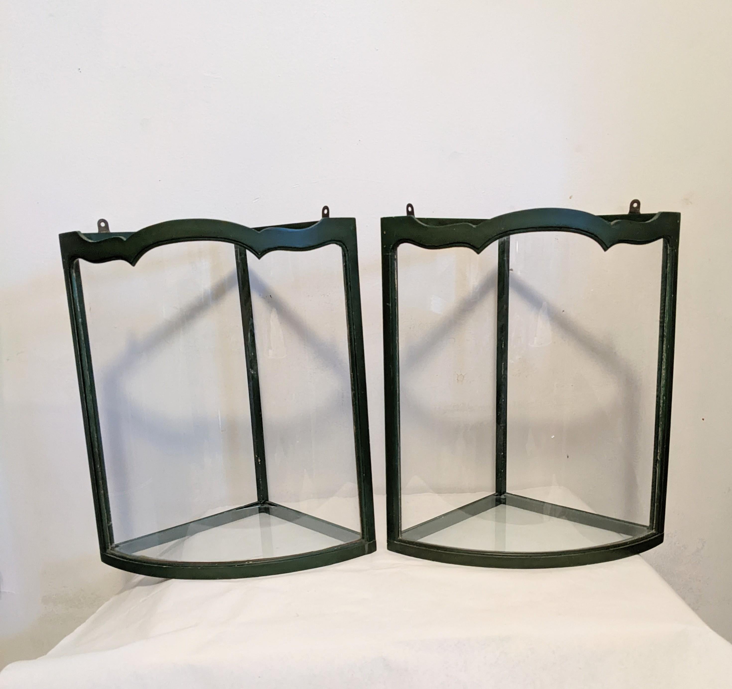 Charming Art Deco corner vitrines or photophores for objects or candles. Painted and carved wood frame in deep green with carved glass. 1930's USA. 
Each 14.5 high, 13