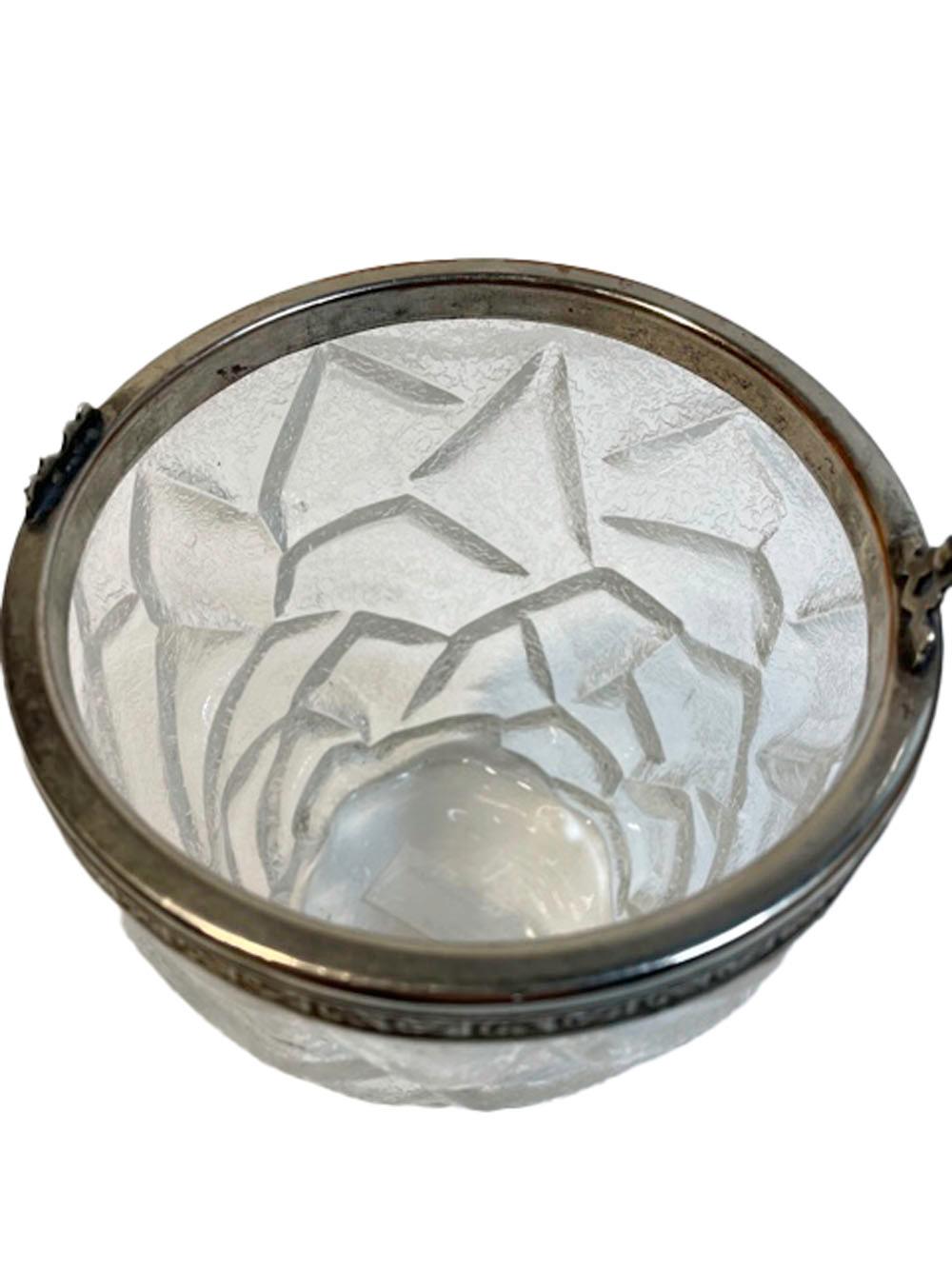 Vintage molded glass ice bucket of pail form with a frosted surface molded to resemble cracked ice. The silver plate rim with leaf molded side and attached swing handle.