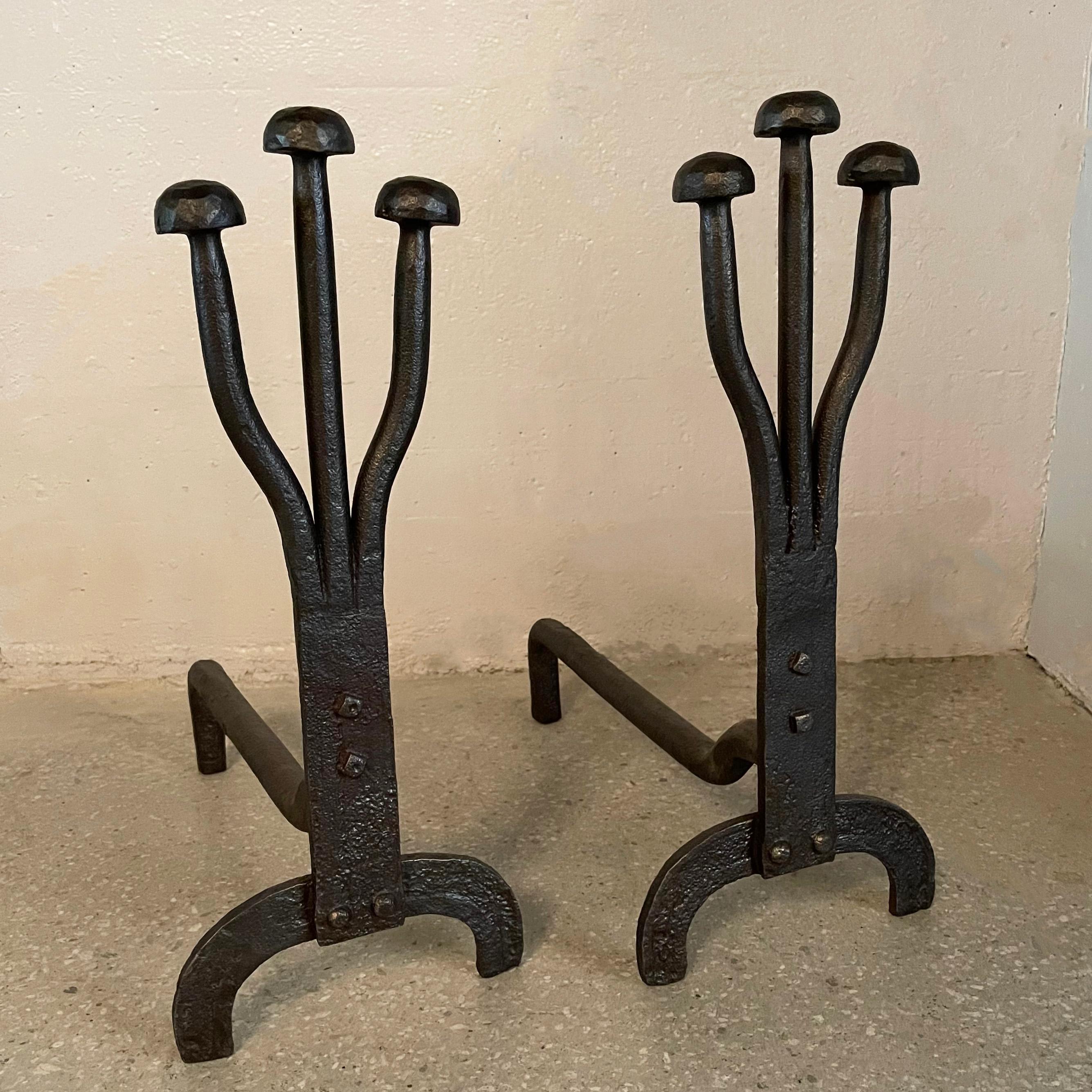 Pair of art deco, hand-forged, andirons feature a sprouting mushroom motif.