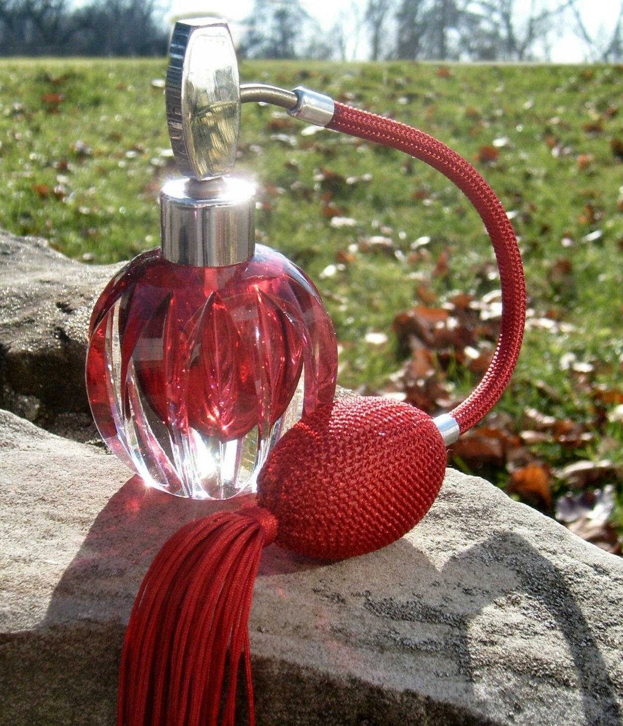 For your consideration is this beautiful Art Deco cranberry colored glass atomiser perfume bottle. Chrome accents to the neck and top. The body of the bottle is glass and quite weighty, feels like very good quality. Lovely condition and with a