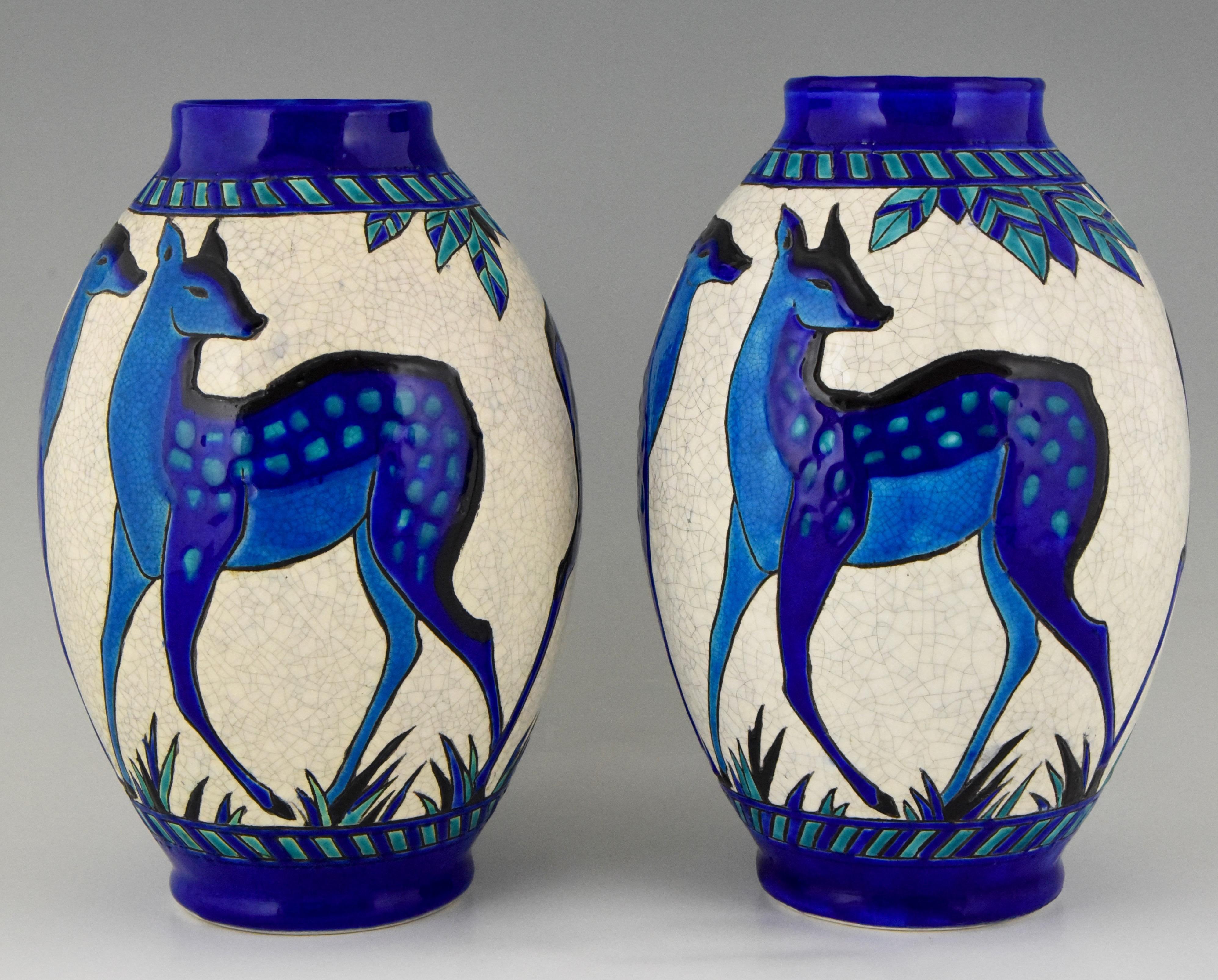 Very nice pair of Art Deco vases with blue deer designed by Charles Catteau from the line Biches Bleues for Keramls, Belgium. 1924/1925.The line was exhibited at the 1925 Exposition Internationale des Arts Decoratifs et Industriels in Paris.