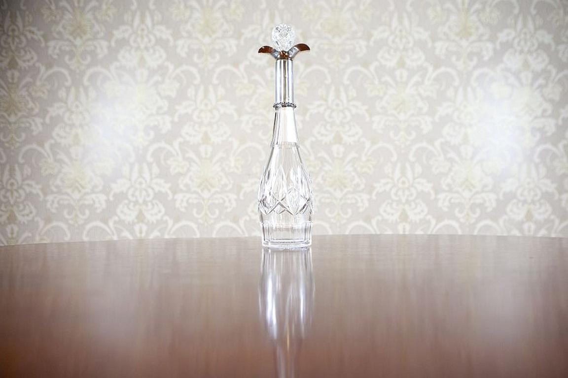 Art Deco Crystal Decanter From the Early 20th Century with Silver Neck

We present you this crystal decanter with original hand-made cut. The upper section of the neck is finished with a noble fitting of a silver collar with a profiled funnel.
The