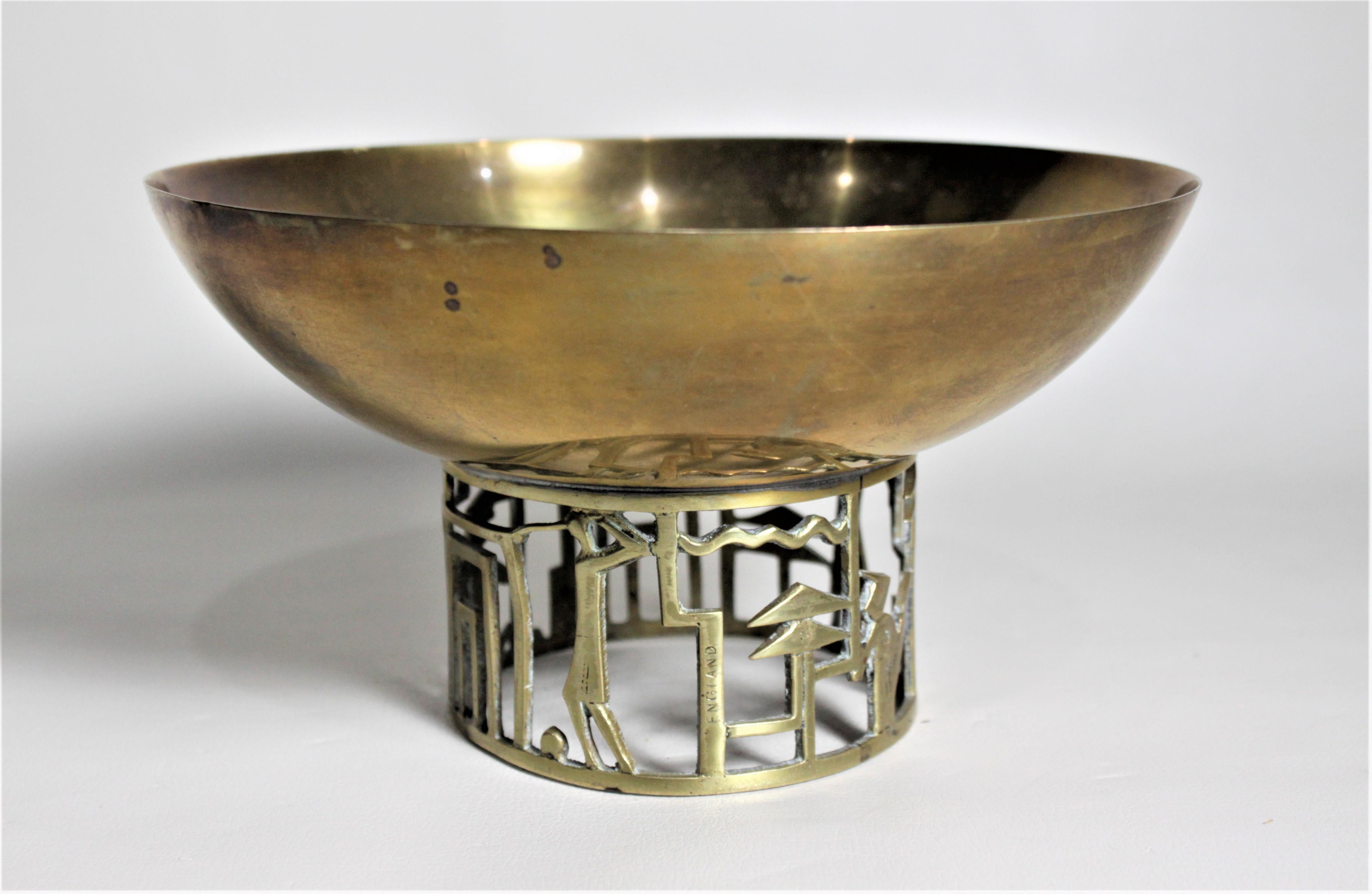 This handcrafted brass pedestal bowl was made during the Art Deco period in a cubist style depicting stylized golf scenes in the base. This bowl is commonly attributed to Karl Hagenauer and the Werkstatte factory of Vienna, but curiously this bowl