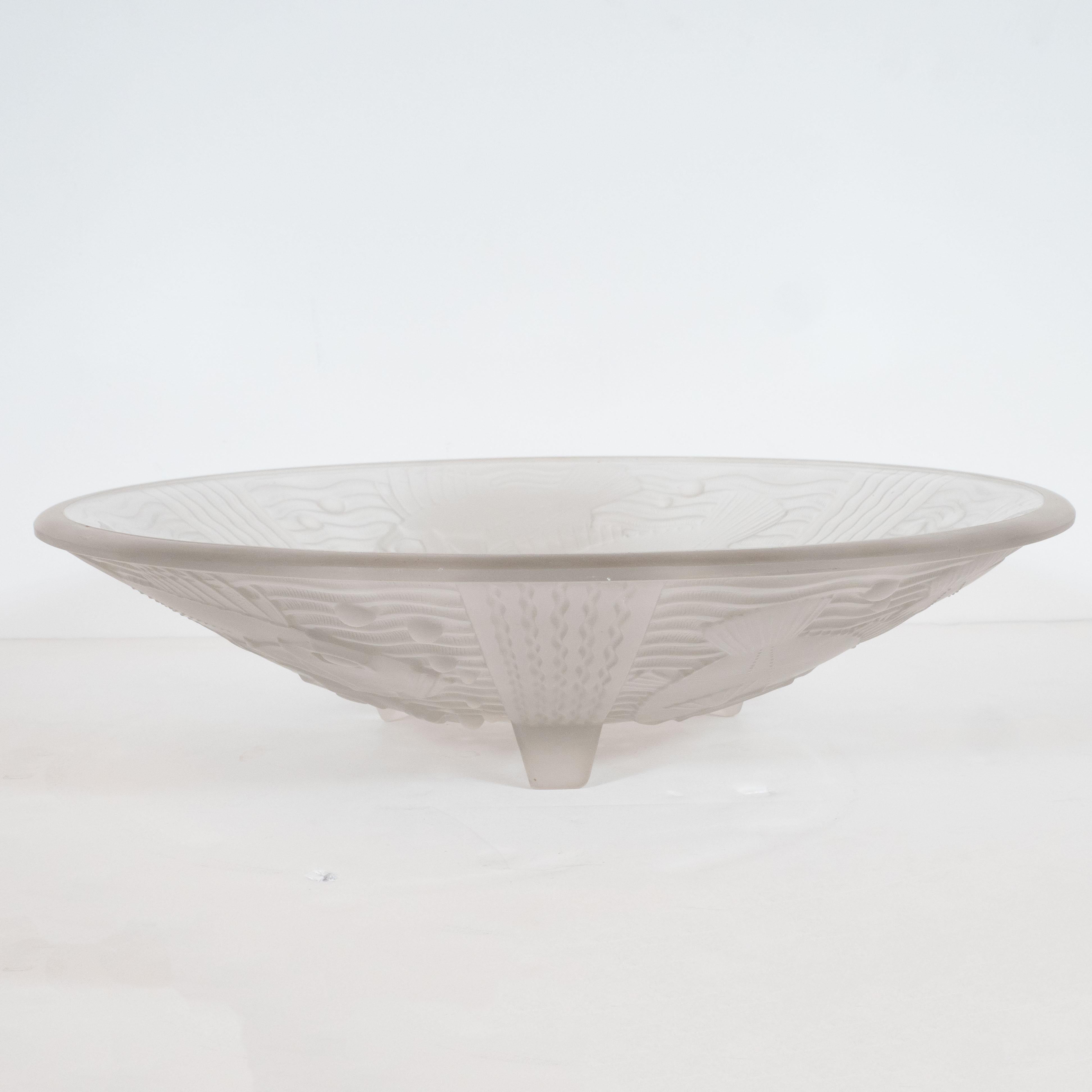 This elegant Art Deco centerbowl was realized by the esteemed French atelier Pierre D'Avesn, circa 1930. Sitting on three curved feet, the piece features stylized renditions of rockfish- a type of aquatic species that existed in plenitude off of the