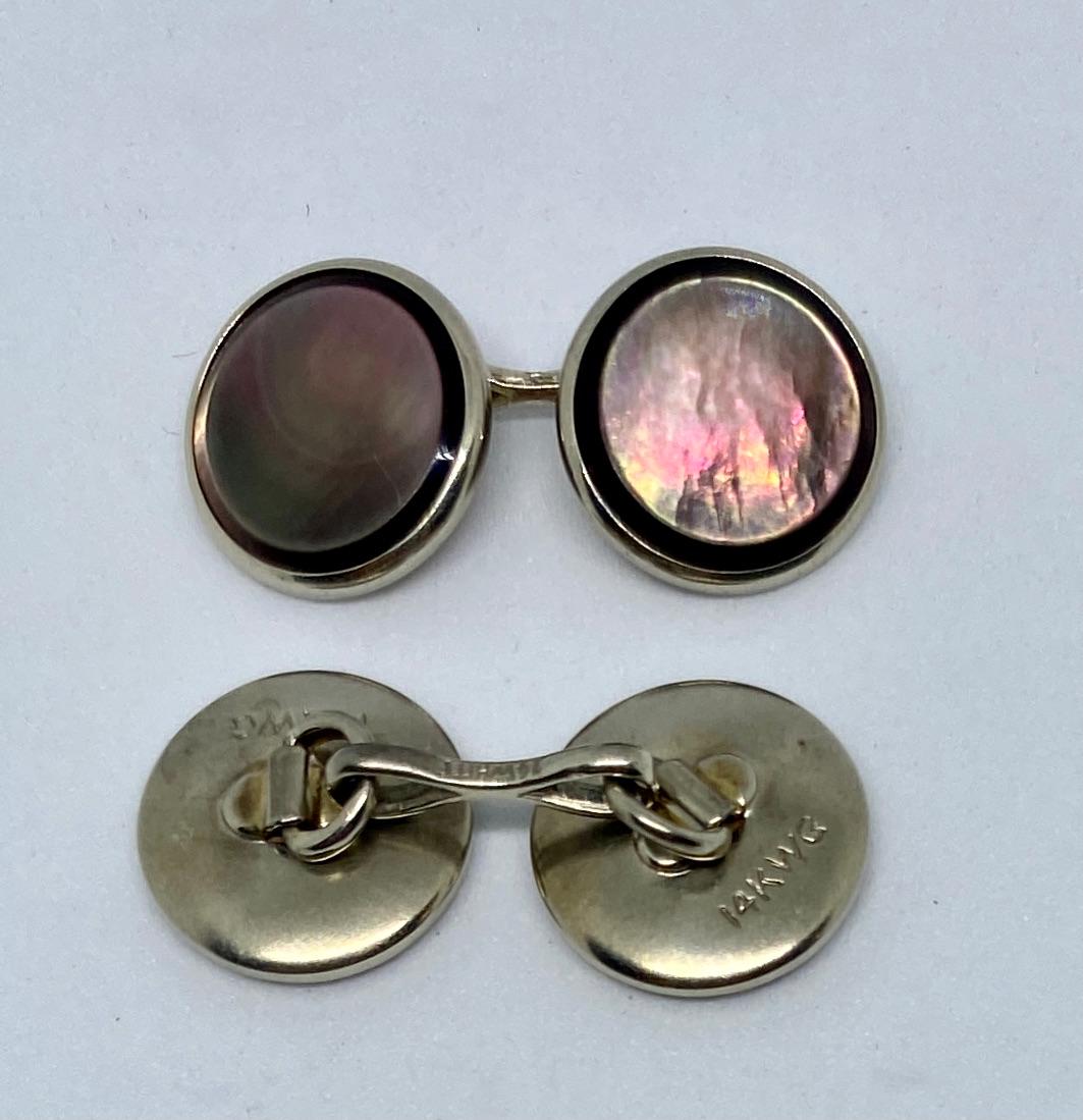 Classic, handsome, double-sided round cufflinks in solid, 14K white gold with beautiful, richly colored abalone mother-of-pearl faces by Larter & Sons, one of the preeminent makers of high-quality American jewelry in the Art Deco period.

The four