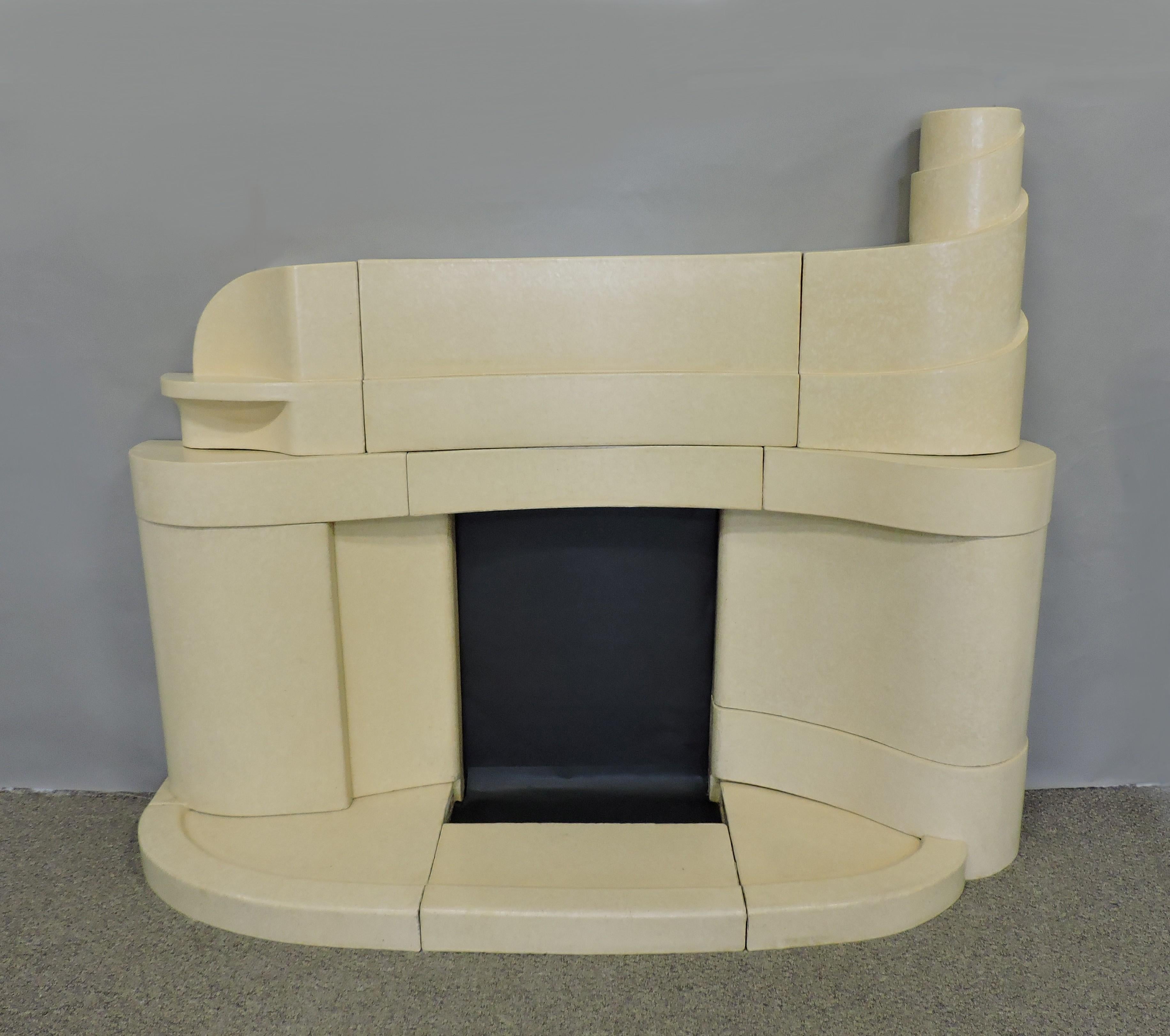Stunning and unique Art Deco fireplace mantel in a curvaceous, stepped design. This mantel is made of ceramic faience block with a mottled beige and white glaze. The layers of curved shapes are reminiscent of a steamship. A real statement piece that