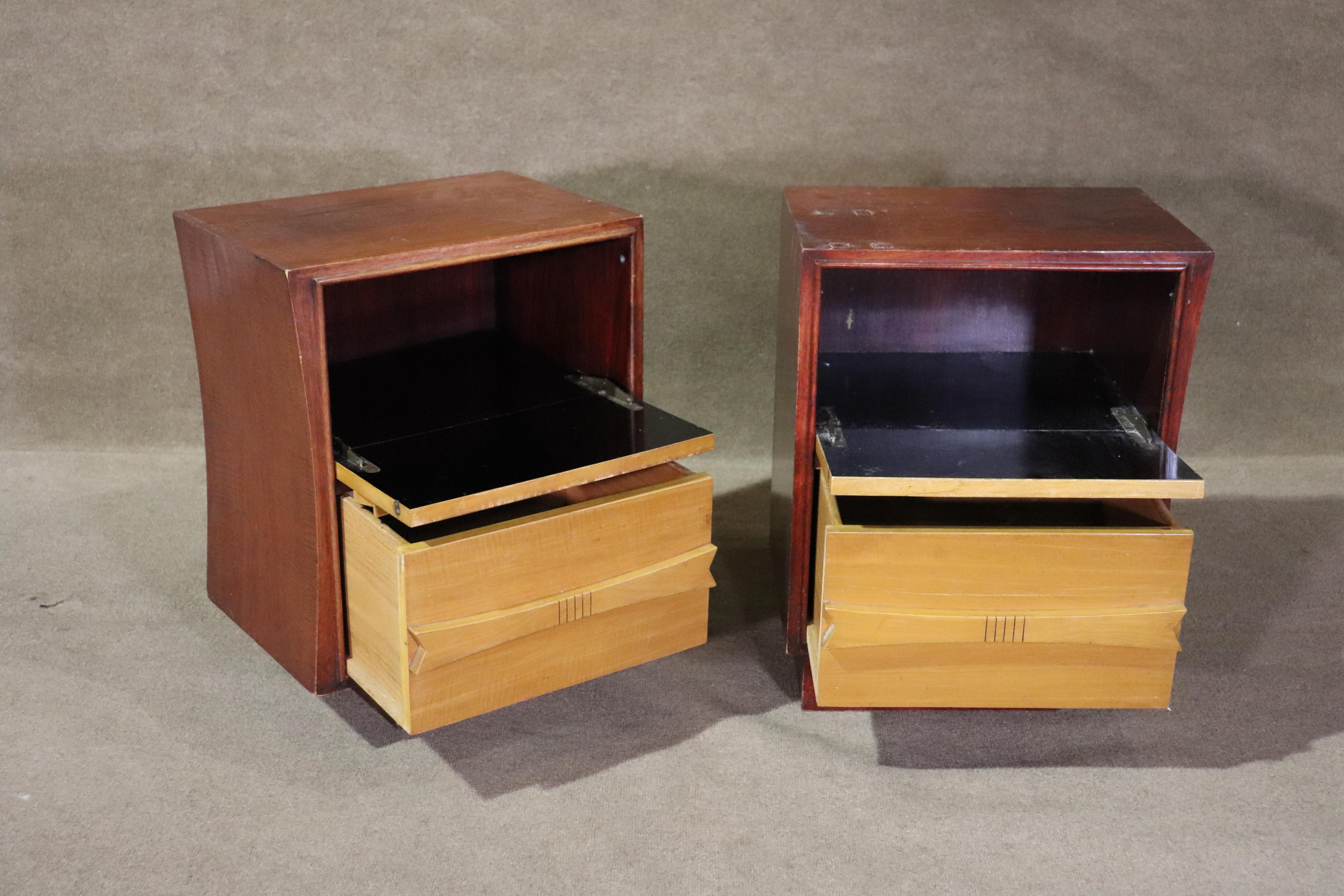Pair of bedside nightstands with two tone wood and sculpted handles. Top drawer is fake and fold down for cabinet storage. Each table has a curved edge for an elegant bedside design.
Please confirm location NY or NJ