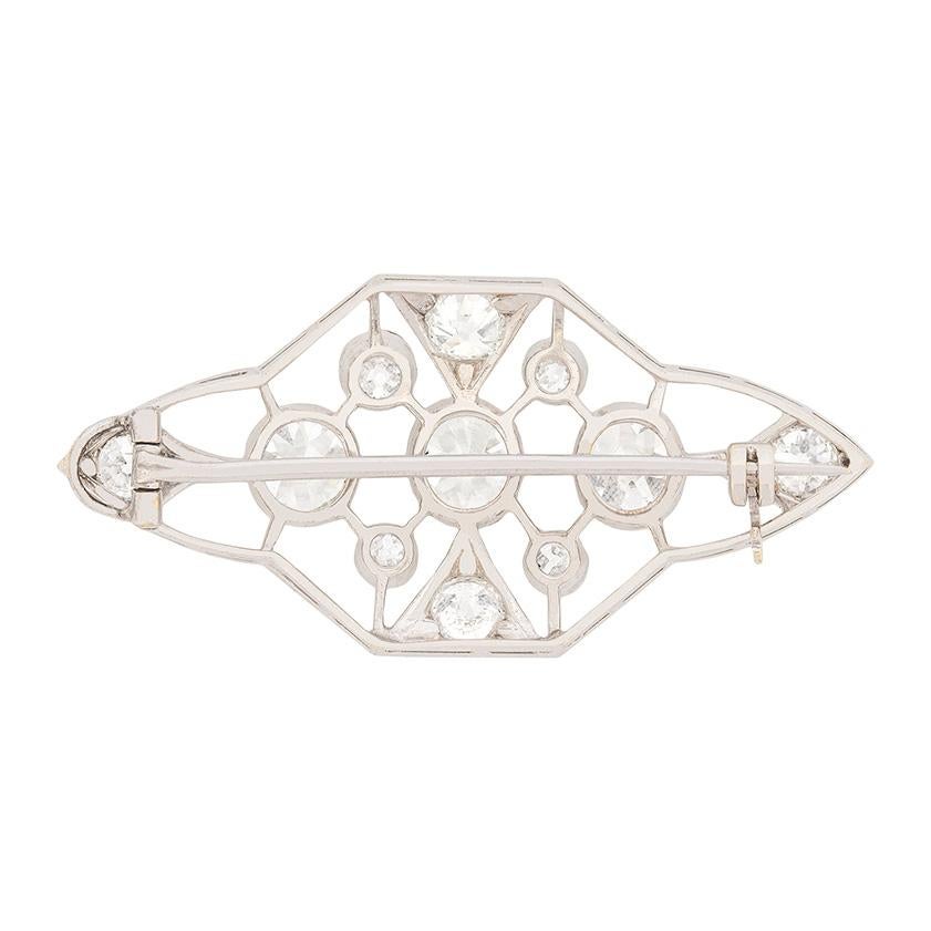 This elegant diamond brooch dates to the 1920s and feature a collection of old, cushion cut, diamonds. There are three main stones in the middle of the piece, with the centre diamond weighing 0.85 carat and the two either side, each weighing 0.75