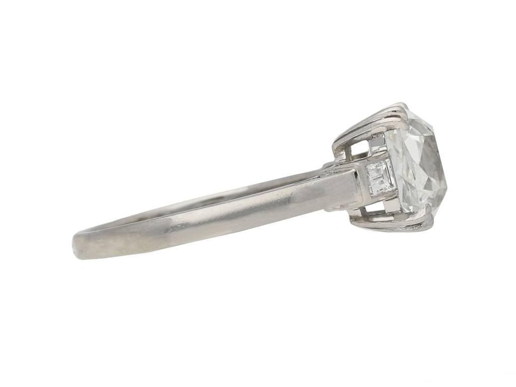Art Deco cushion shape old mine diamond ring. Set with a cushion shape old mine diamond, G colour, VS2 clarity with a weight of 2.18 carats in an open back four claw setting, flanked by two rectangular baguette cut diamonds in open back rubover