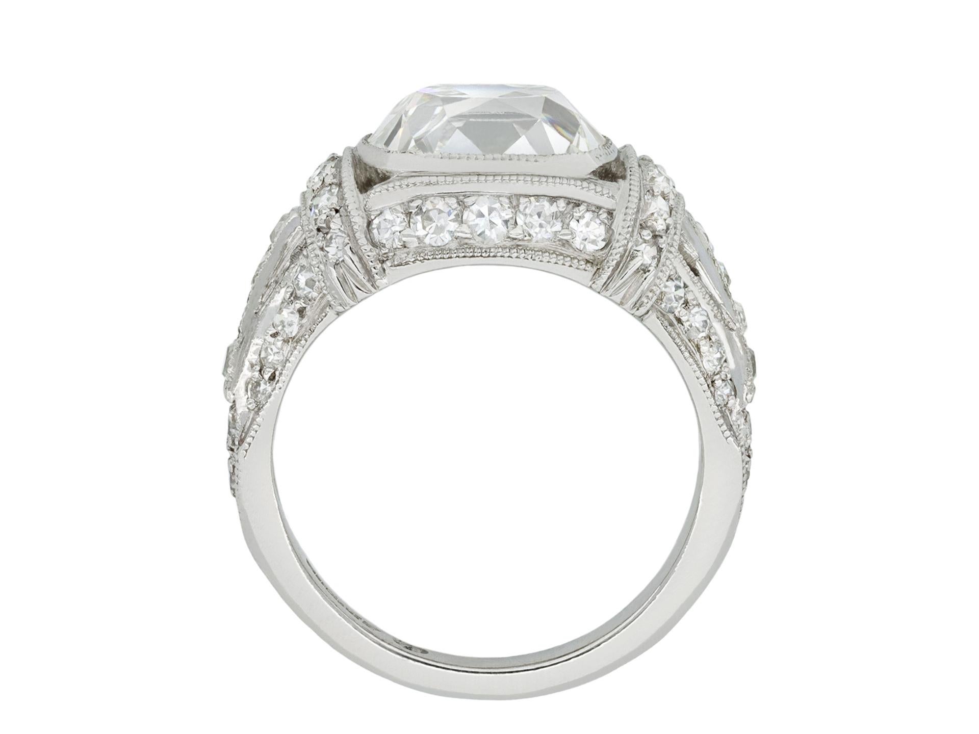 Art Deco cushion shape old mine diamond ring. Set to centre with a cushion shape old mine diamond, J colour, VVS2 clarity, with a weight of 3.24 carats in an open back rubover setting, flanked by eight cushion shape French cut diamonds in open back
