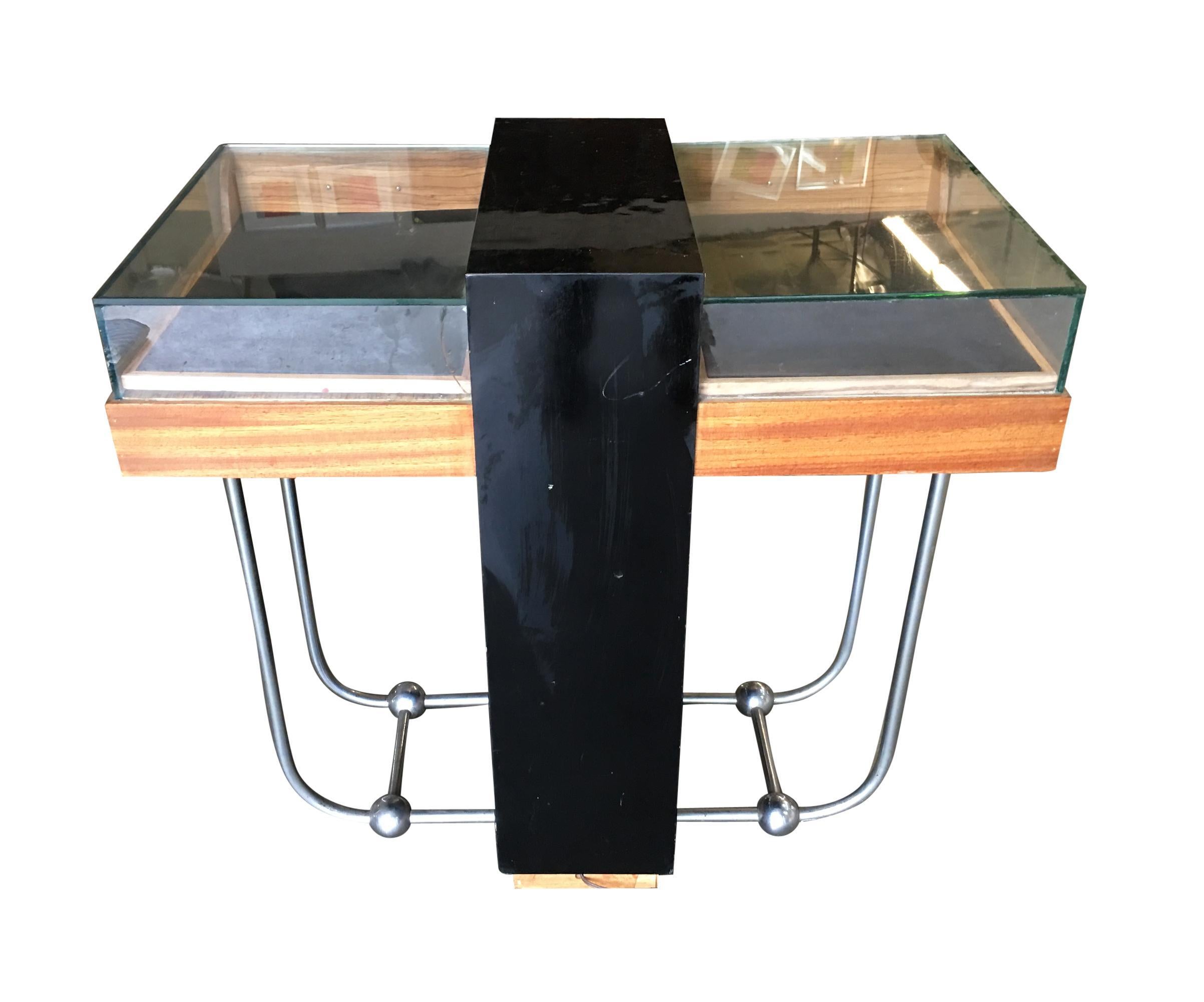Vintage custom-built light-up art deco jewelry display case featuring 2 separate light-up displays with pull-out trays, four drawers, and all resting on chromed streamline legs. There is slight wear on the piece due to age.

Dimension: 31