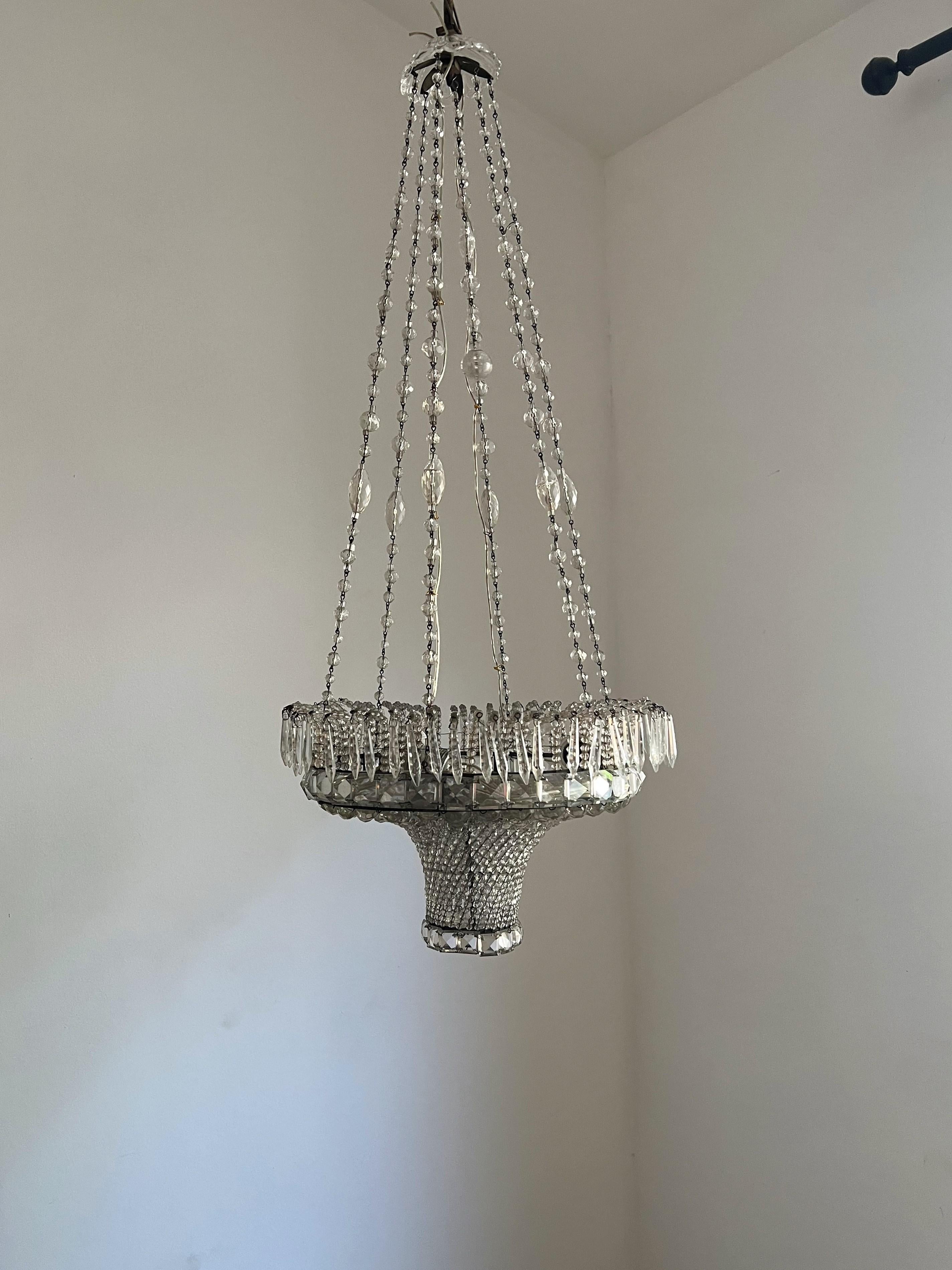 Art Deco chandelier manufactured in hand cut crystal and a metal frame.
Each of the glass drops has been hand cut and assembled into this beautiful piece of art.
There is a matching pair of sconces listed separately in our shop.
The Chandelier holds