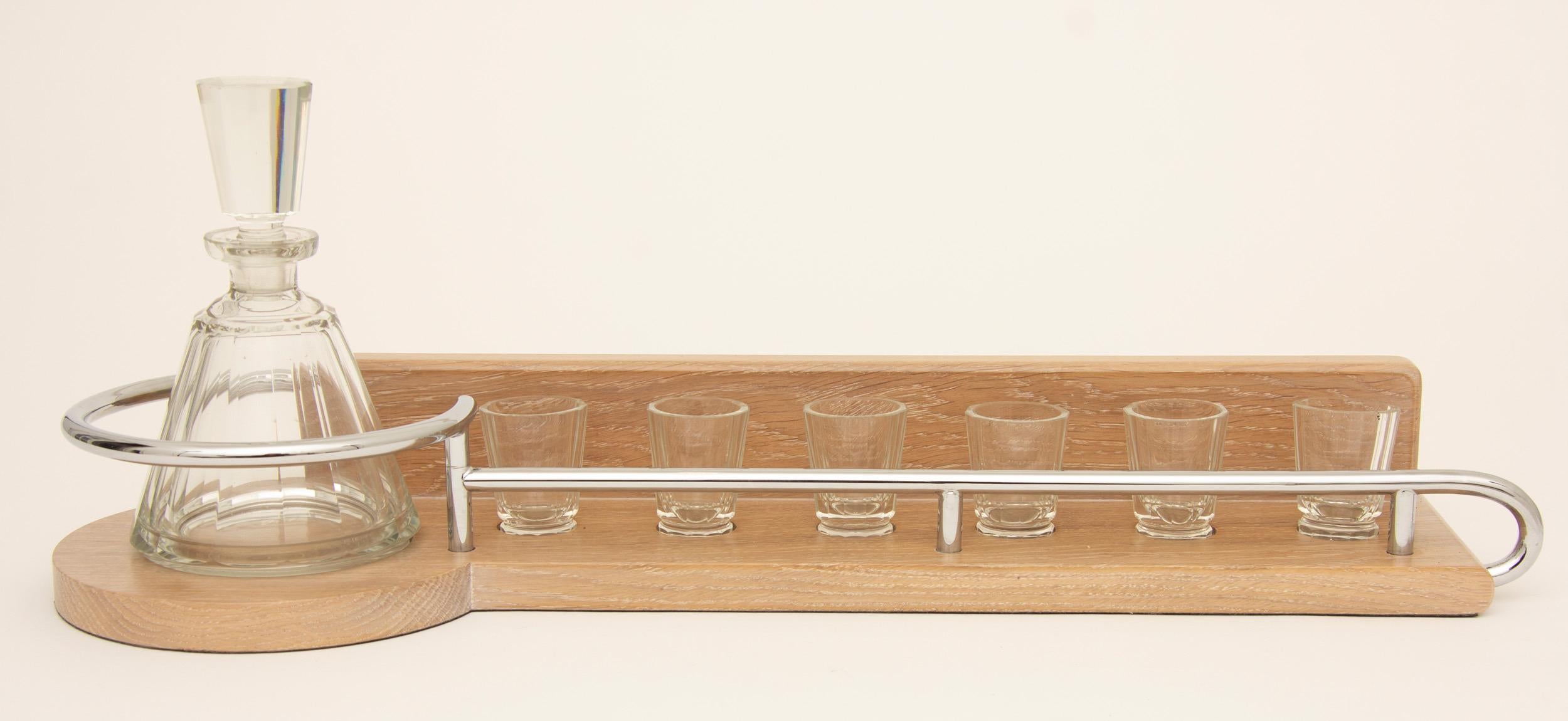 French Art Deco cut crystal liquor set with a modernist limed oak and chrome tray.
Beautifully presented Art Deco liquor set by the renowned designer Adnet.
French, circa 1930.
Measures: H 21 cm, W 60 cm, D 18 cm.