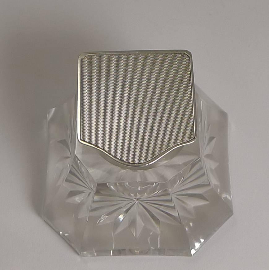 A really handsome vintage art deco inkwell, beautifully shaped and star cut on the underside. The collar and hinged lid is made from sterling silver and the top of the lid beautifully engine turned.

The silver is fully hallmarked for Birmingham