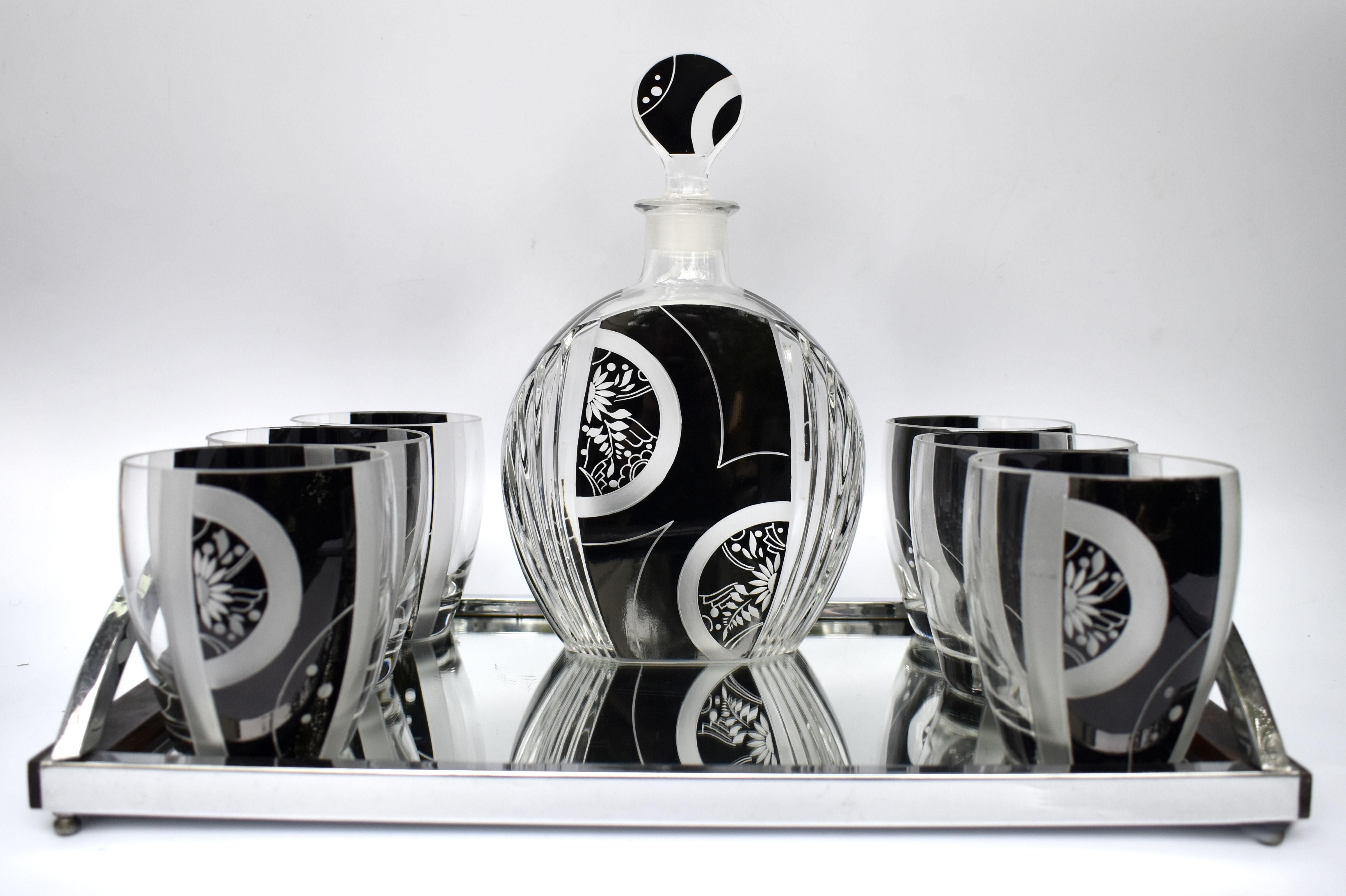 Extremely stylish Art Deco decanter set dating to the 1930's and originating from Prague, Czech Republic. Geometric enamelling in black decorates the attractive and stunning shape glasses & decanter. Comprises decanter with stopper and 6 glasses.