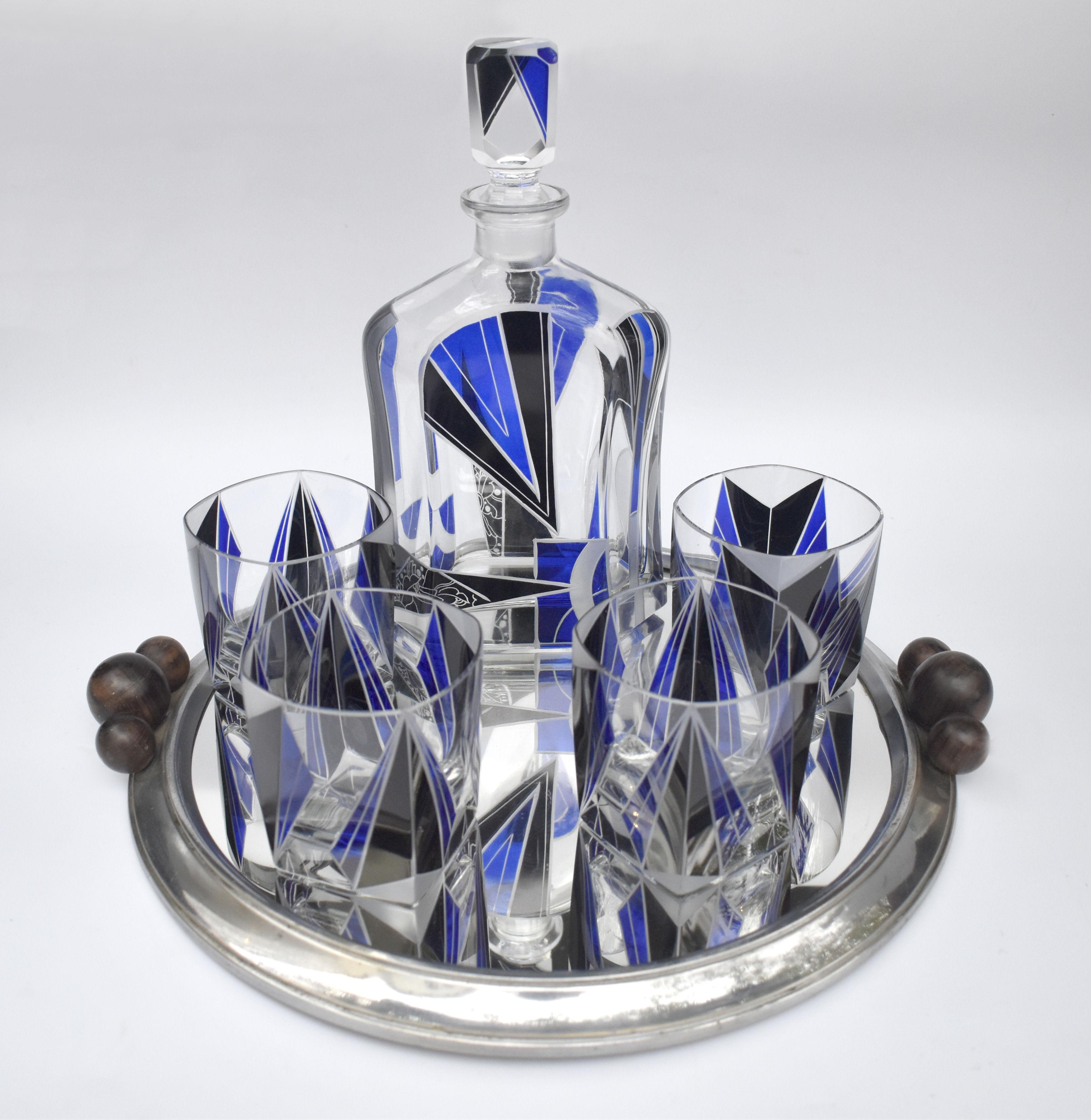 Extremely stylish Art Deco decanter set dating to the 1930's and originating from Prague, Czech Republic. Geometric enamelling in black & royal blue decorates the attractive and stunning shape glasses & decanter. Comprises decanter with stopper and