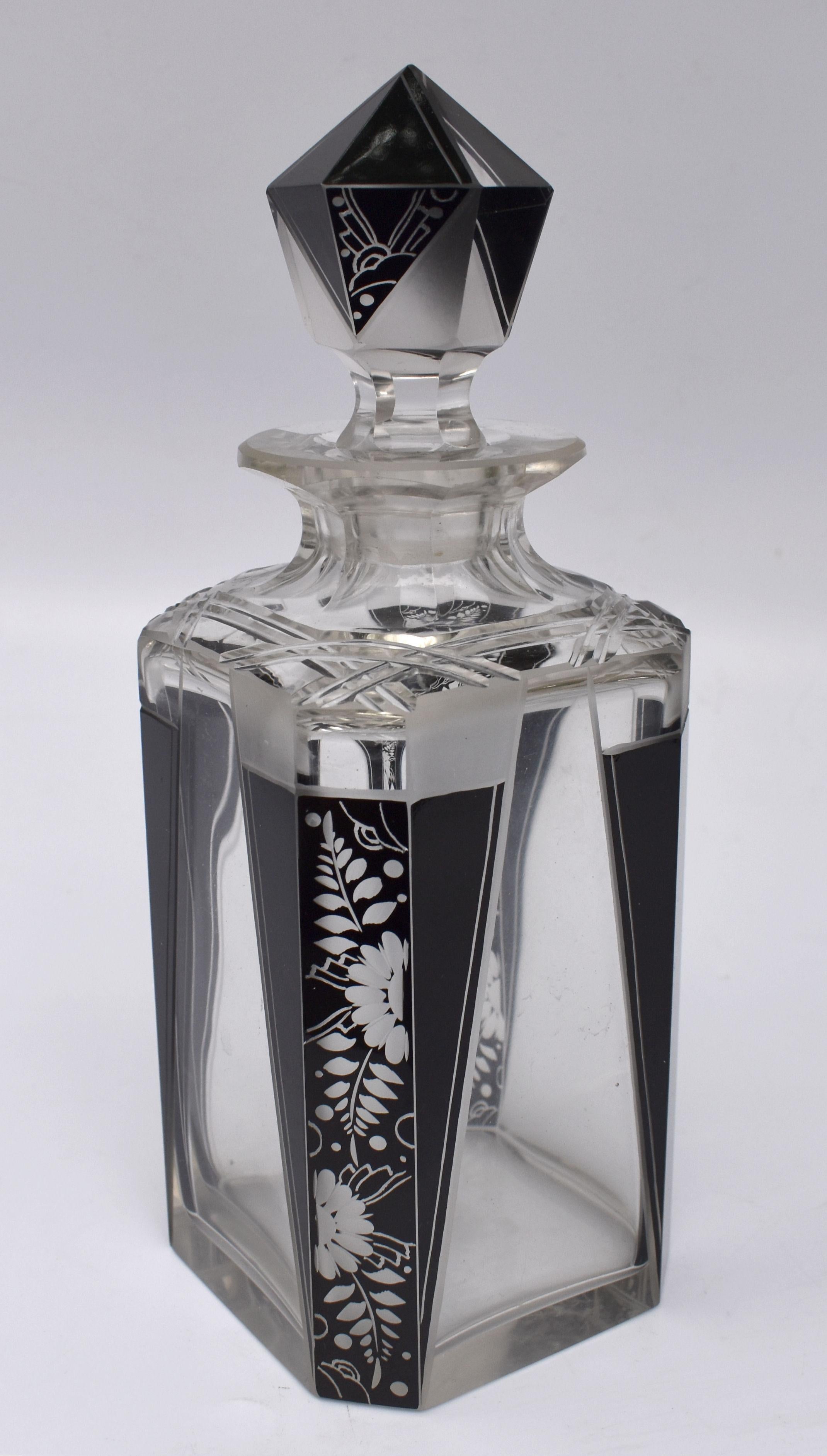 Extremely stylish Art Deco whiskey decanter set dating to the 1930's and originating from Prague, Czech Republic. Clear crystal glass is decorated with enamelling in black . Comprises decanter with stopper and 6 glasses. Condition is very good, no