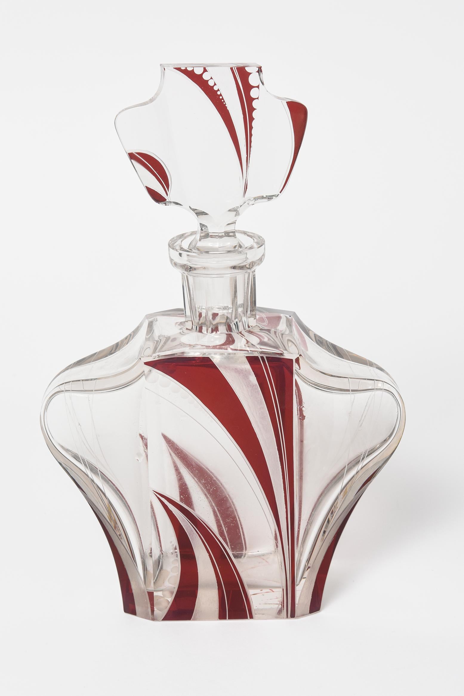 Extremely stylish Bohemian Art Deco decanter set from the 1930s and originating in the Czech Republic.
With its timeless elegance, this finely crafted decanter set is embellished with stunning and unusual red geometric enamel as well as frosted