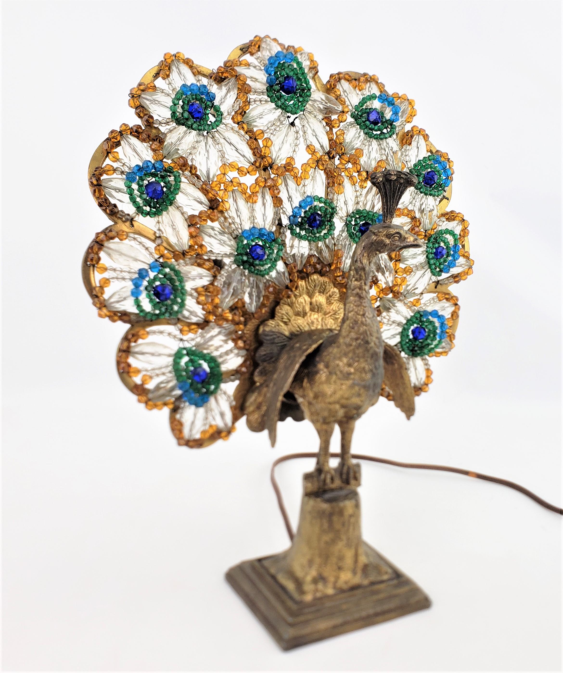 This antique figural peacock lamp is unsigned, but presumed to have been in the former Czech Republic in approximately 1920 in a period Art Deco style. The lamp is ornately cast of spelter and show considerable detail in the feathers and body, which