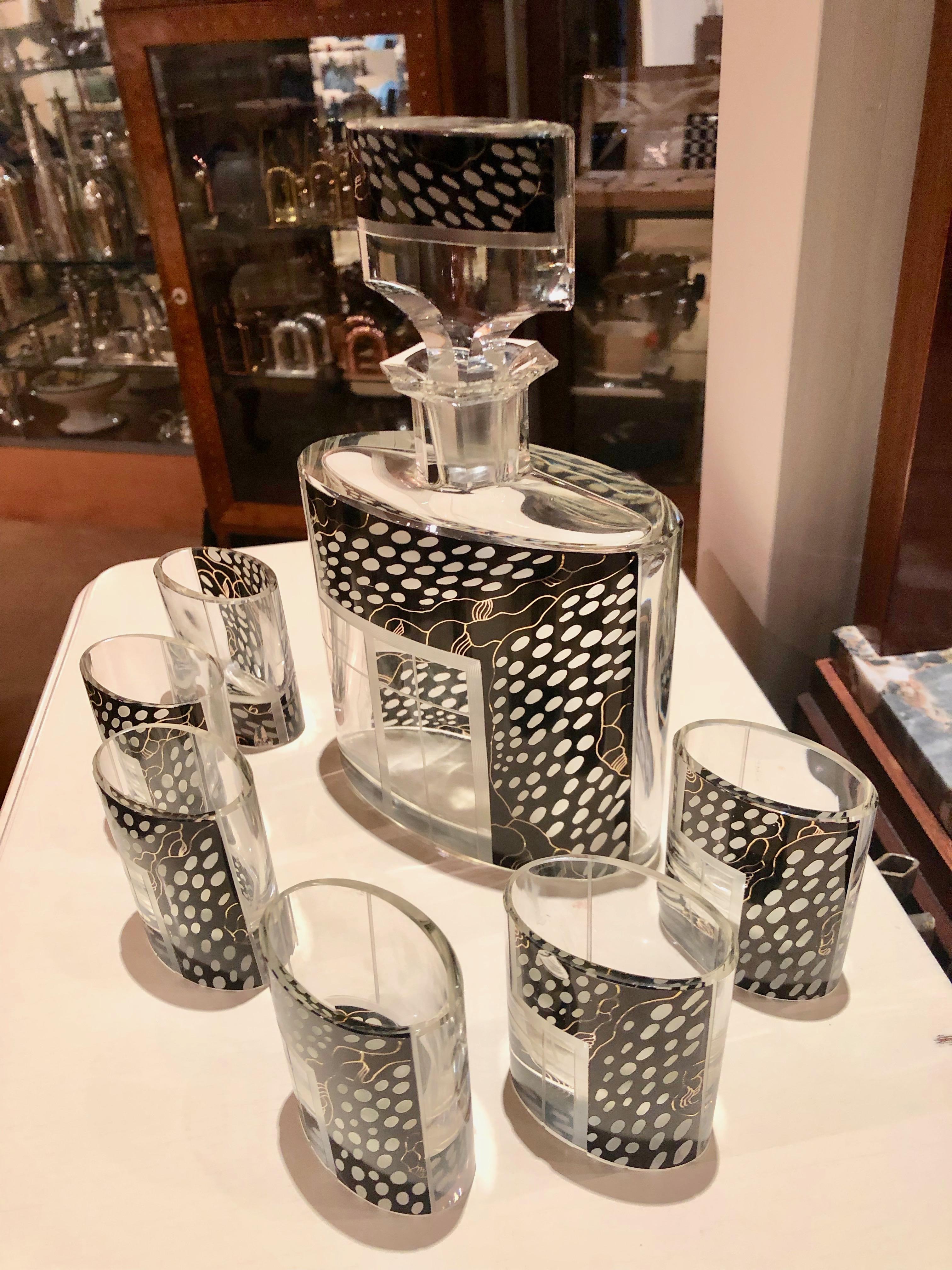 A jazzy Czechoslovakian decanter set embellished with Avant Garde leopard black in a decidedly asymmetric pattern unusual in its time. This handsome piece with matching glasses is in near perfect condition. This unique set has a lot going on for it.