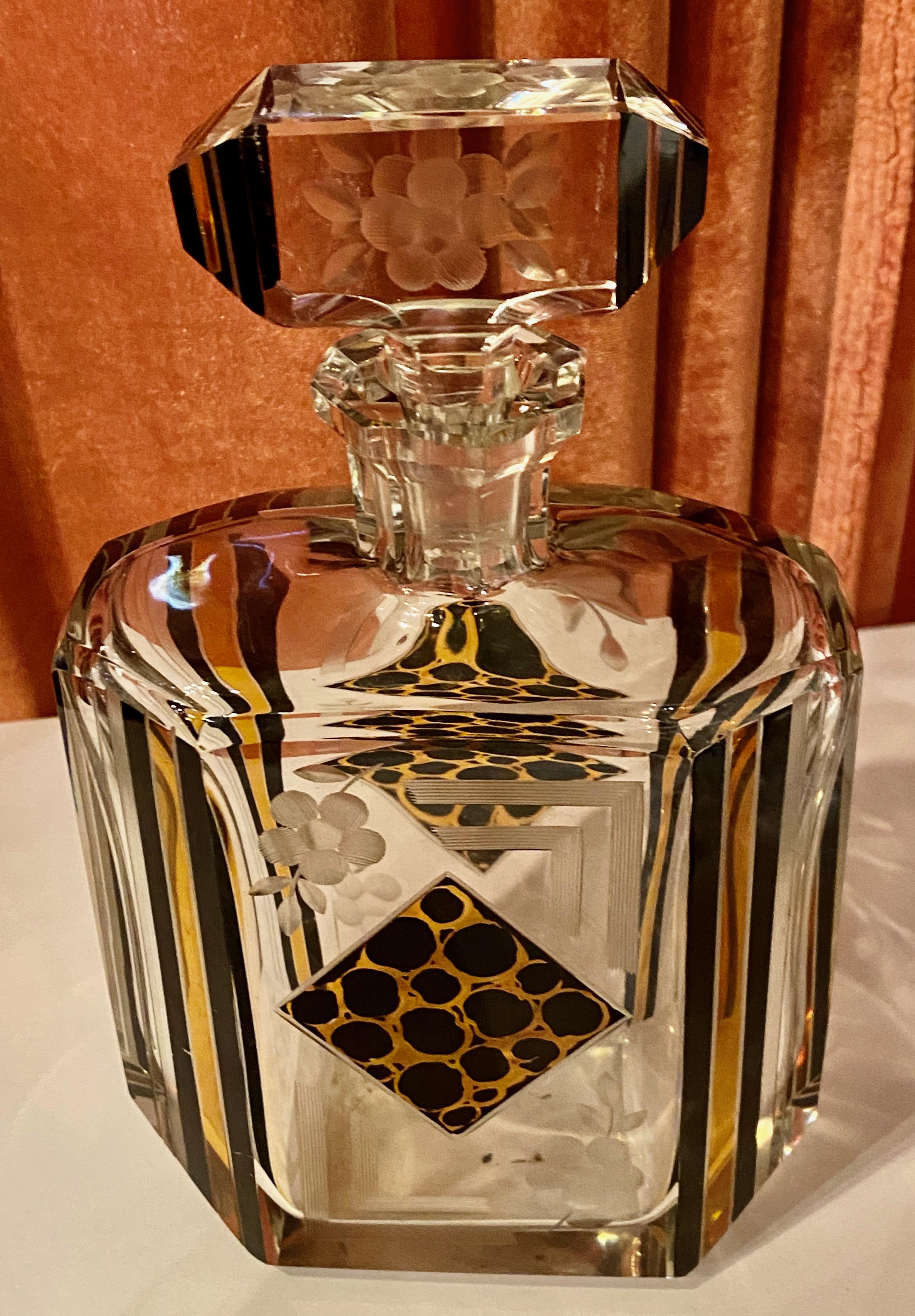 A jazzy Czechoslovakian Decanter set embellished with Avant Garde leopard black and gold in a decidedly symmetric diamond pattern unusual in its time with banded black and gold lines. There are also engraved florals on all pieces. This handsome set