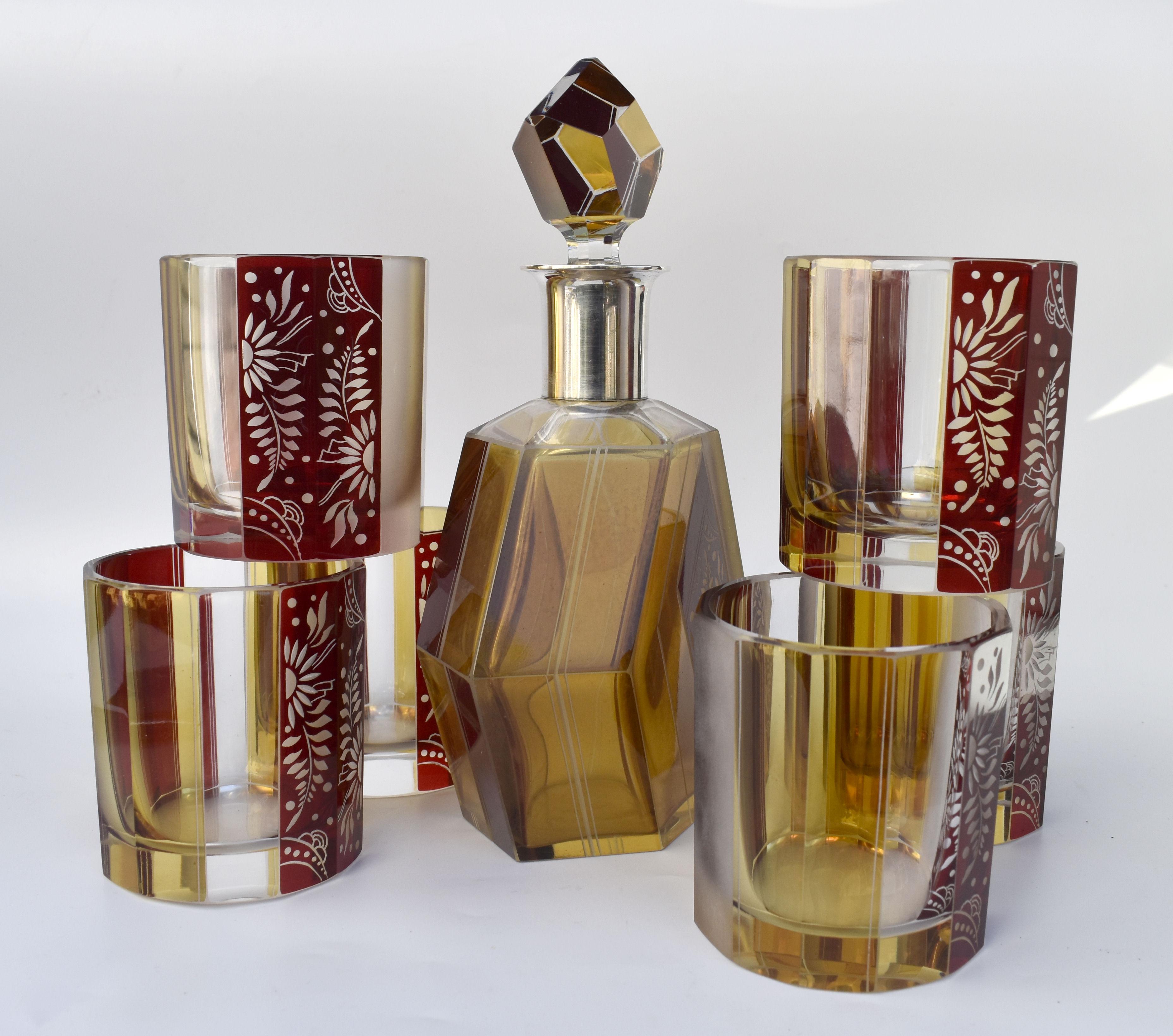 Wonderfully stylish Art Deco 1930's crystal glass decanter set which comes with six matching glasses and decanter with stopper, the whole being heavily enamelled with geometric floral decoration. Glass is an attractive frosted etched design in a