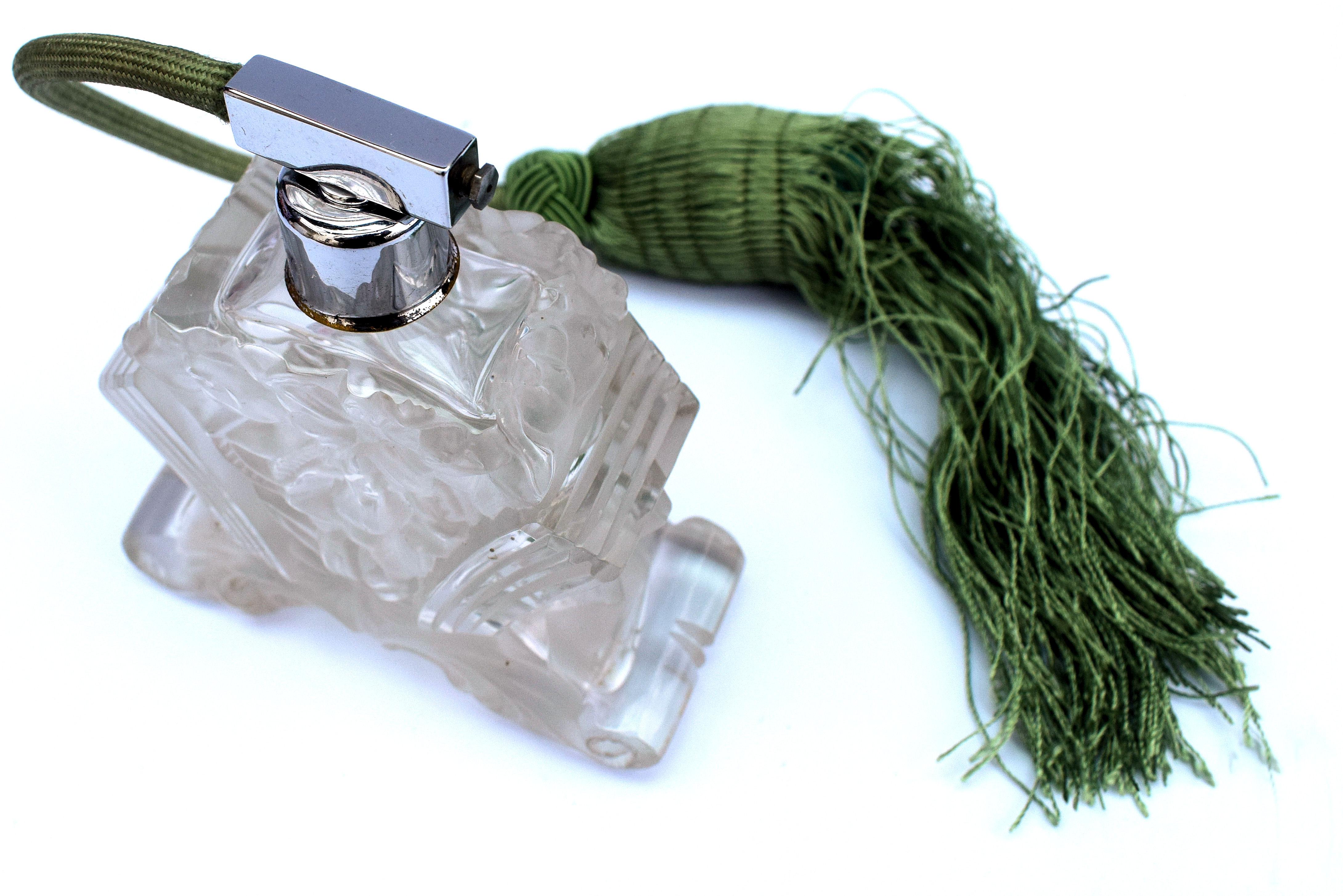 A beautiful Art Deco atomizer in thick heavy transparent glass with frosted and clear accents. Handmade in Bohemia around 1930 and is a great example of Czechoslovakian Art Deco. The body of the atomizer is standing on an arched base. making the