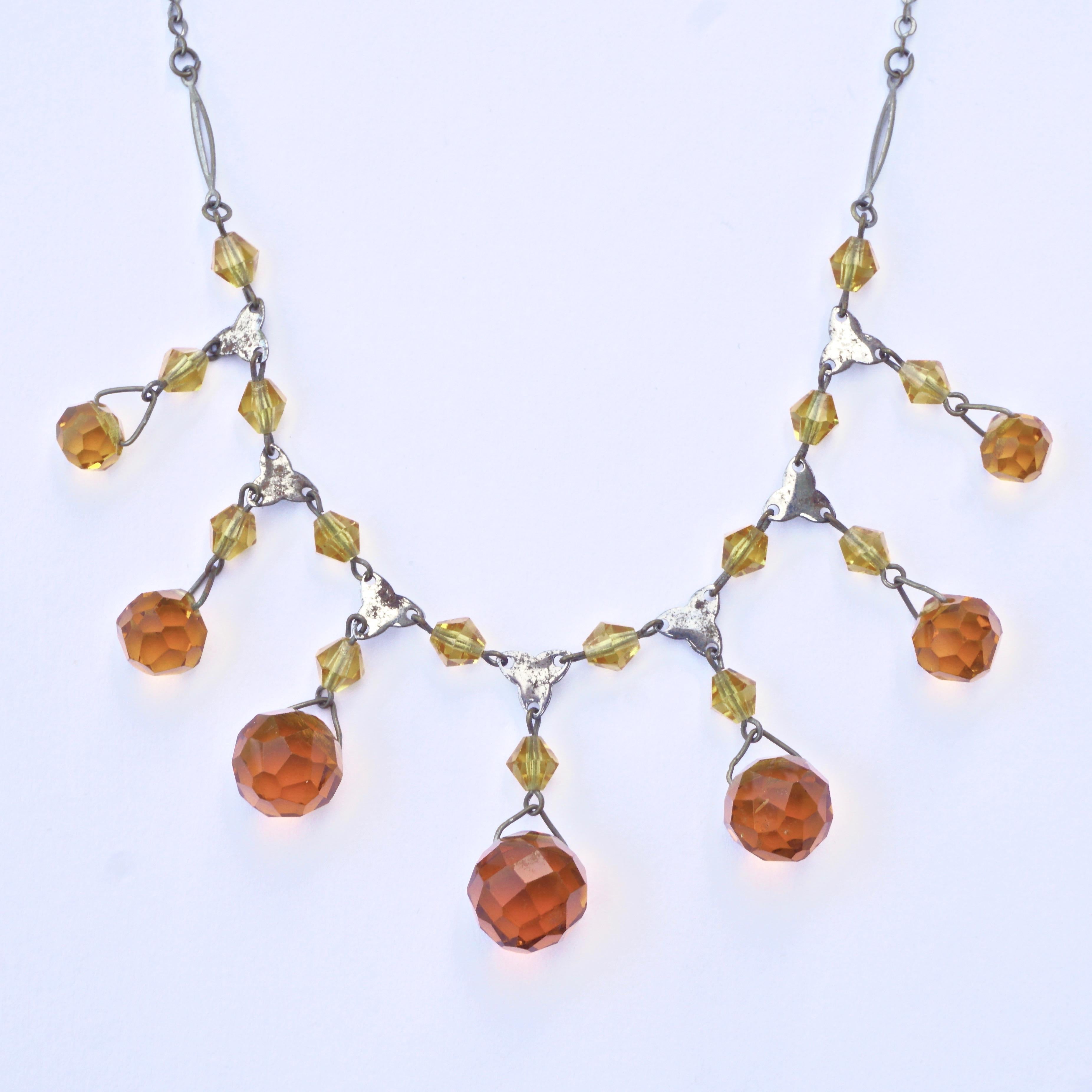 Beautiful Art Deco Czech silver plated necklace, featuring seven amber glass ball drops which are graduated in size and colour, bi-cone beads and decorative spacers. Measuring length 41.1cm / 16.2 inches, and the largest amber drop is 1.15cm / .45