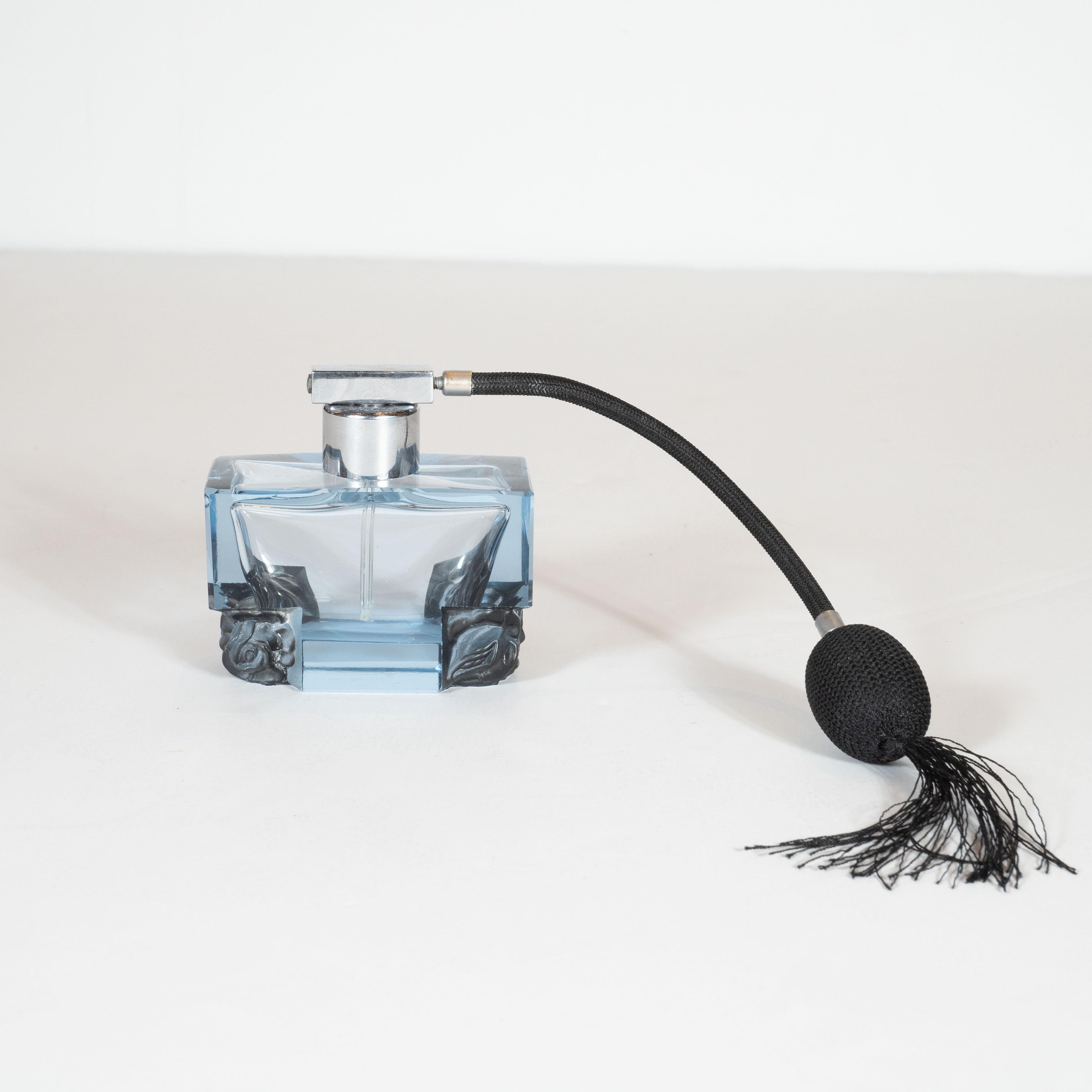 This stunning Art Deco perfume atomizer was handcrafted in Czechoslovakia, circa 1930. Composed of a blown and hand pressed glass faceted body in a beautiful translucent sapphire hue, this atomizer/ decorative object offers a stylized floral rose