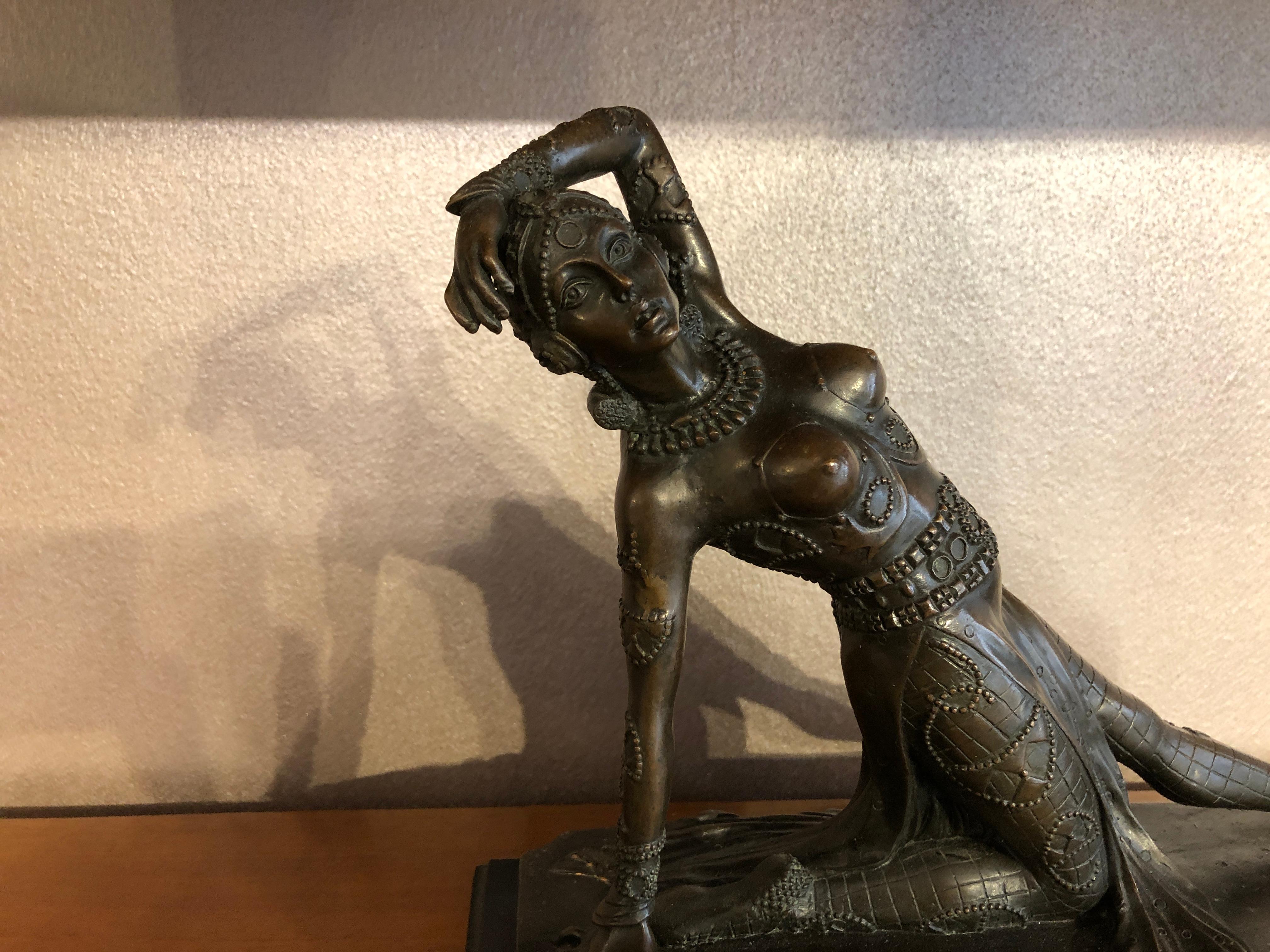 Art Deco dancer bronze sculpture, France, 1930s
Bronze statue of a dancer on a marble pedestal. The sculpture is finely detailed both the face and the clothes. The dancer is on her knee probably at the end of a dancing passage showing the jewelries