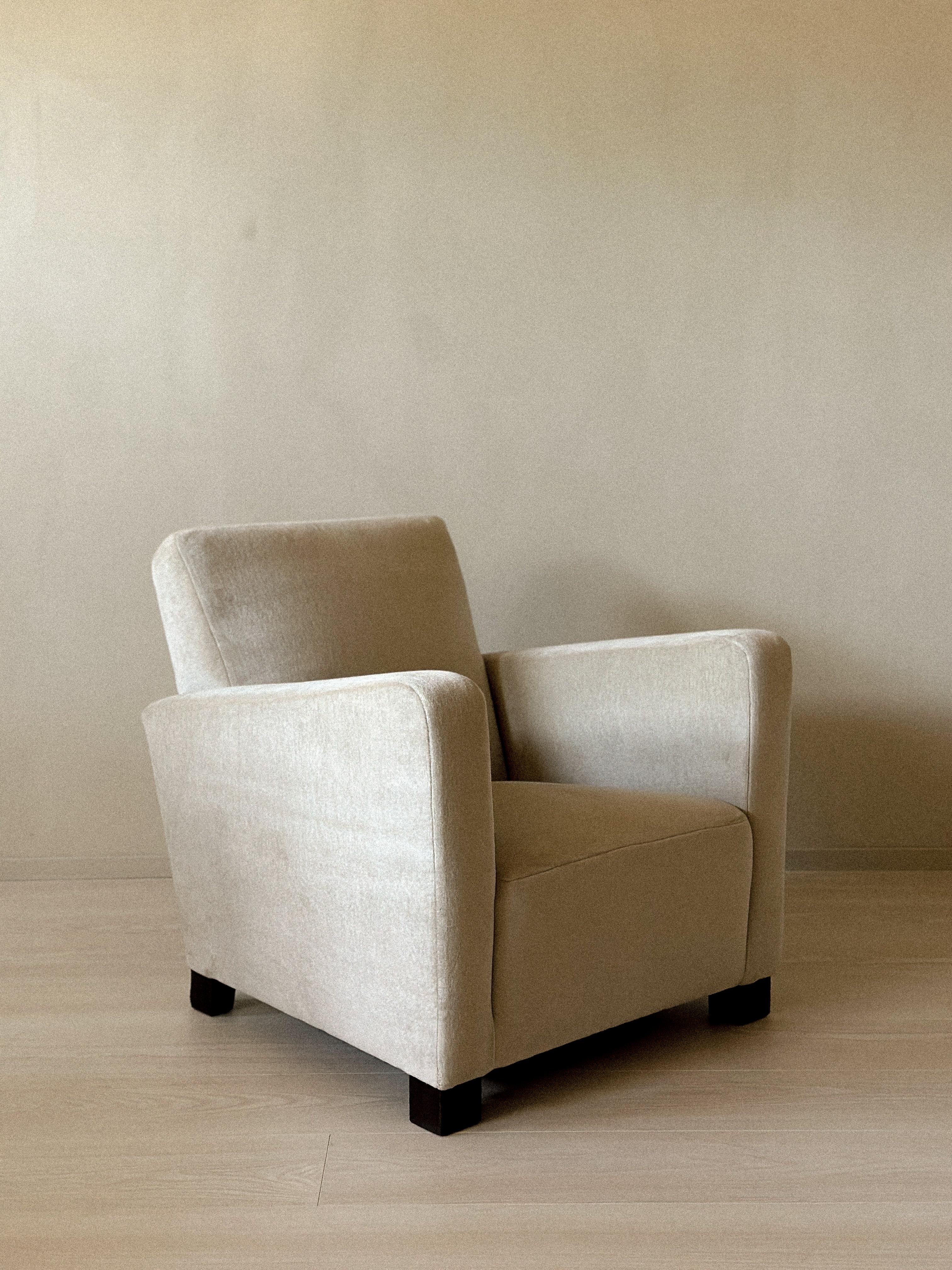 Elegant Art-Deco Danish club chair from the 1940s with clean, geometric lines and understated charm. Recently reupholstered in a soft, neutral fabric, it rests on low wooden block feet. A timeless piece that blends comfort with refined modernist
